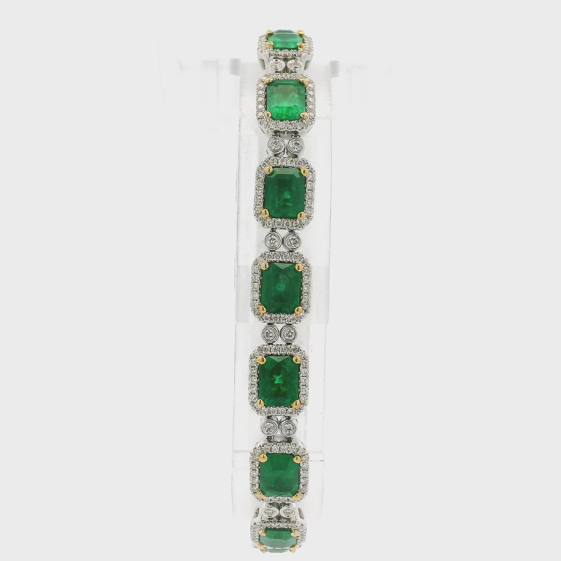 A White Gold Bracelet with prong set emerald cut natural Emeralds in the center with a diamond halo and diamonds between each link at Forever Rox Fine Jewelry, Lake Tahoes Best Jewelry Store