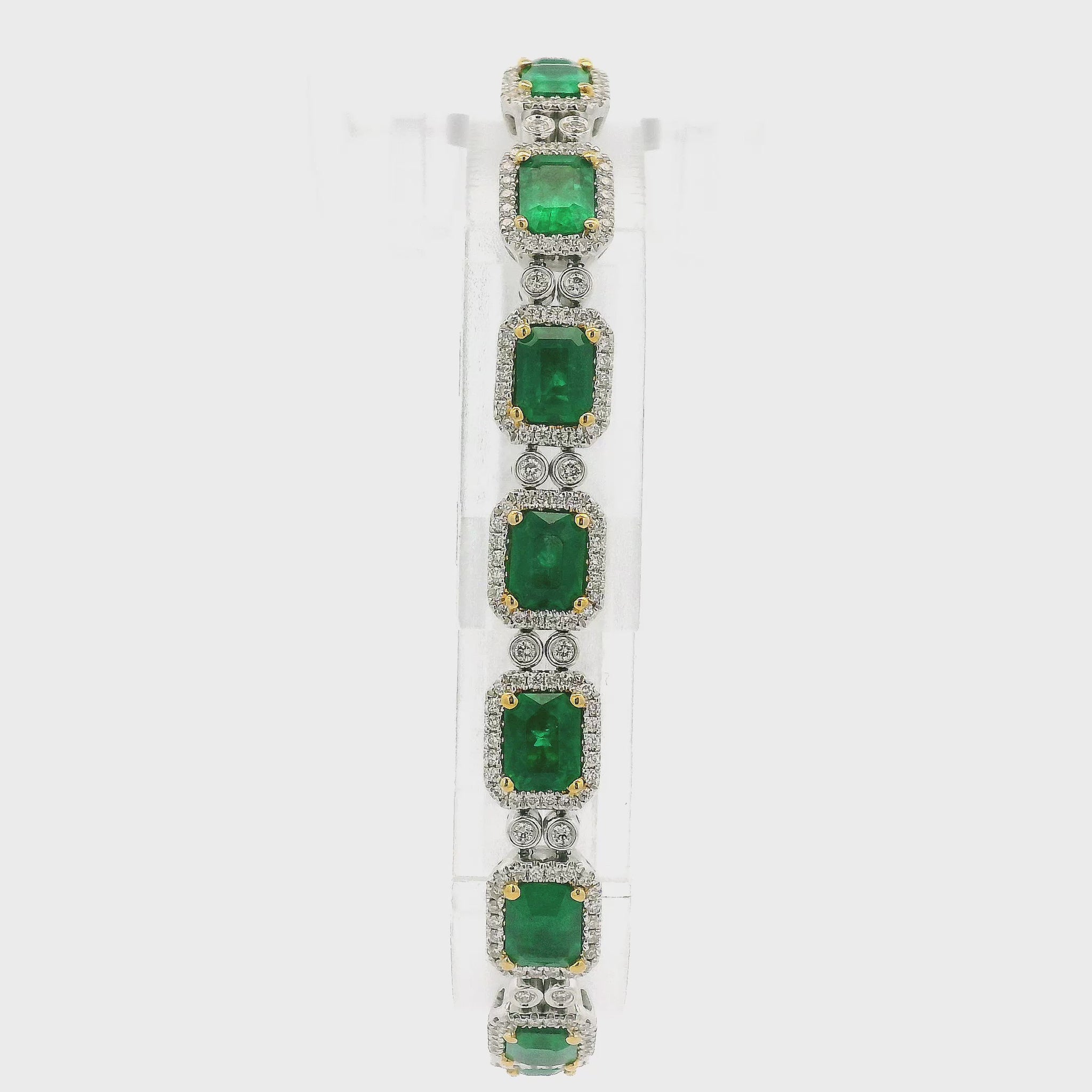 A White Gold Bracelet with prong set emerald cut natural Emeralds in the center with a diamond halo and diamonds between each link at Forever Rox Fine Jewelry, Lake Tahoes Best Jewelry Store