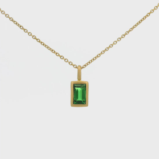 A Yellow Gold Pendant with a solitaire bezel set emerald cut Tsavorite Garnet Forever Rox Fine Jewelry, Lake Tahoes Best Jewelry Store