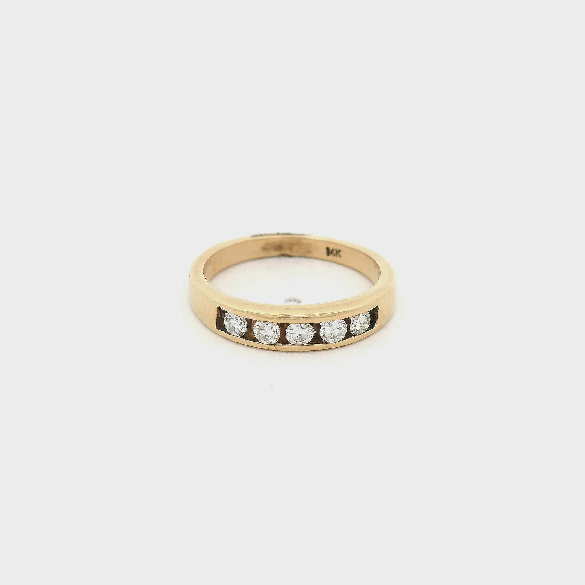 Yellow Gold band with five round cut diamonds set in a channel on the top at Forever Rox Fine Jewelry