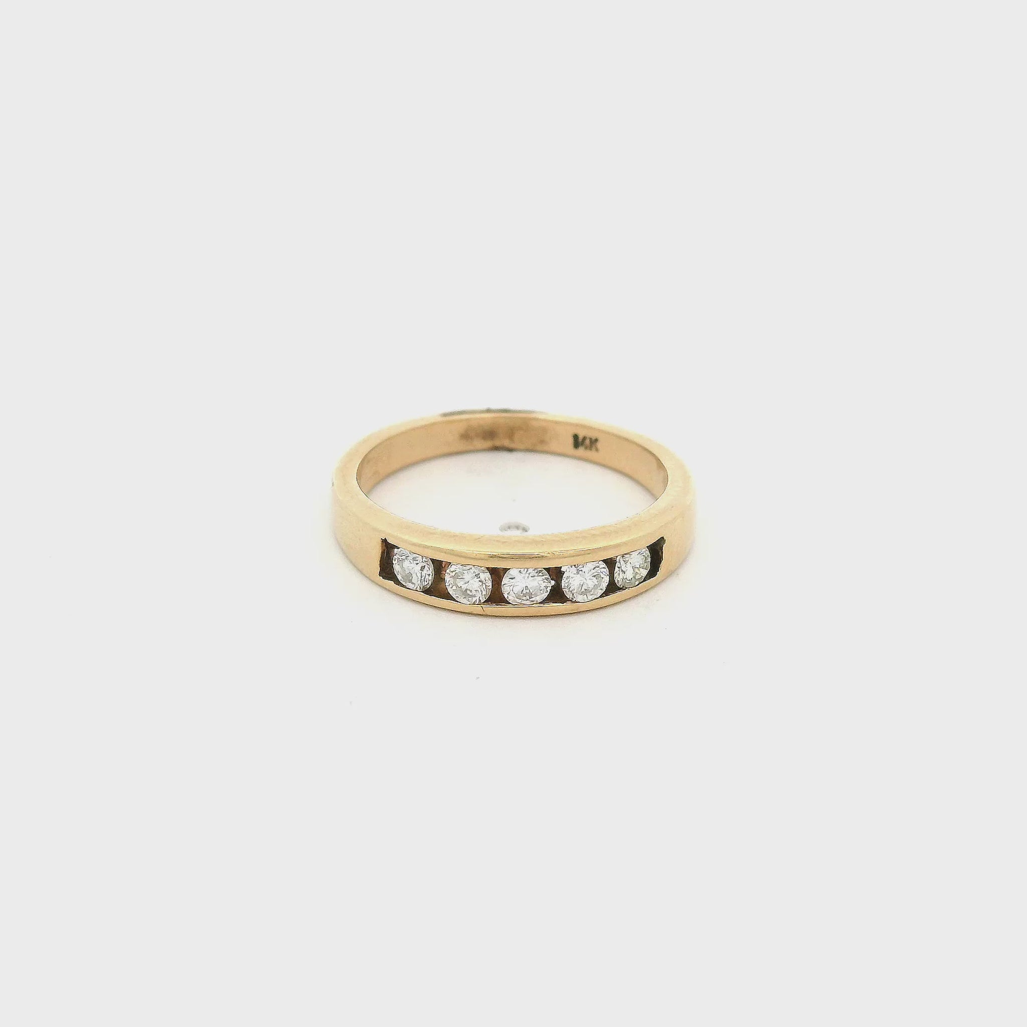 Yellow Gold band with five round cut diamonds set in a channel on the top at Forever Rox Fine Jewelry