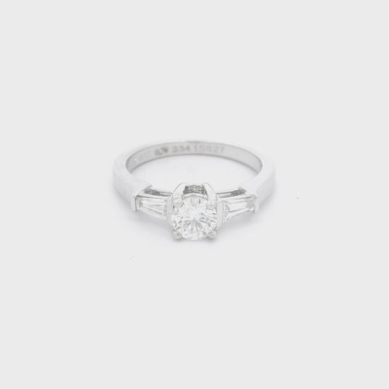 White Gold ring with a round cut diamond in the center and one tapered baguette diamond on each side of the center Diamond at Forever Rox Fine Jewelry