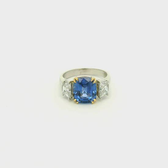A Platinum & Yellow Gold Ring with a prong set natural TGC Certified No Heat Cushion Cut Cornflower Blue Sapphire & 2 Trapazoid Cut Diamonds at Forever Rox Fine Jewelry, Lake Tahoes Best Jewelry Store