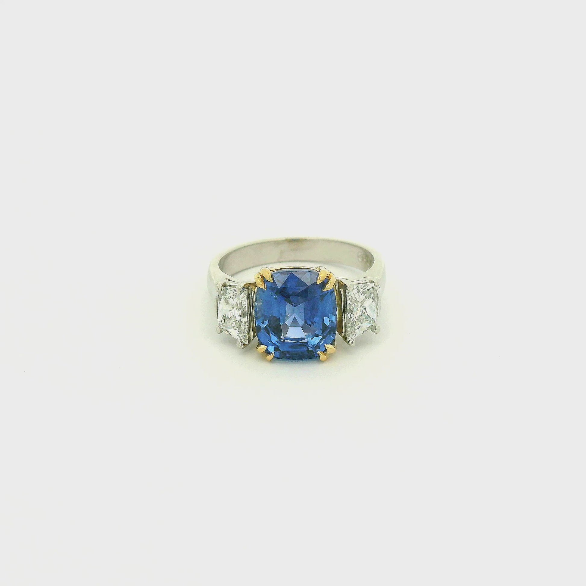 A Platinum & Yellow Gold Ring with a prong set natural TGC Certified No Heat Cushion Cut Cornflower Blue Sapphire & 2 Trapazoid Cut Diamonds at Forever Rox Fine Jewelry, Lake Tahoes Best Jewelry Store