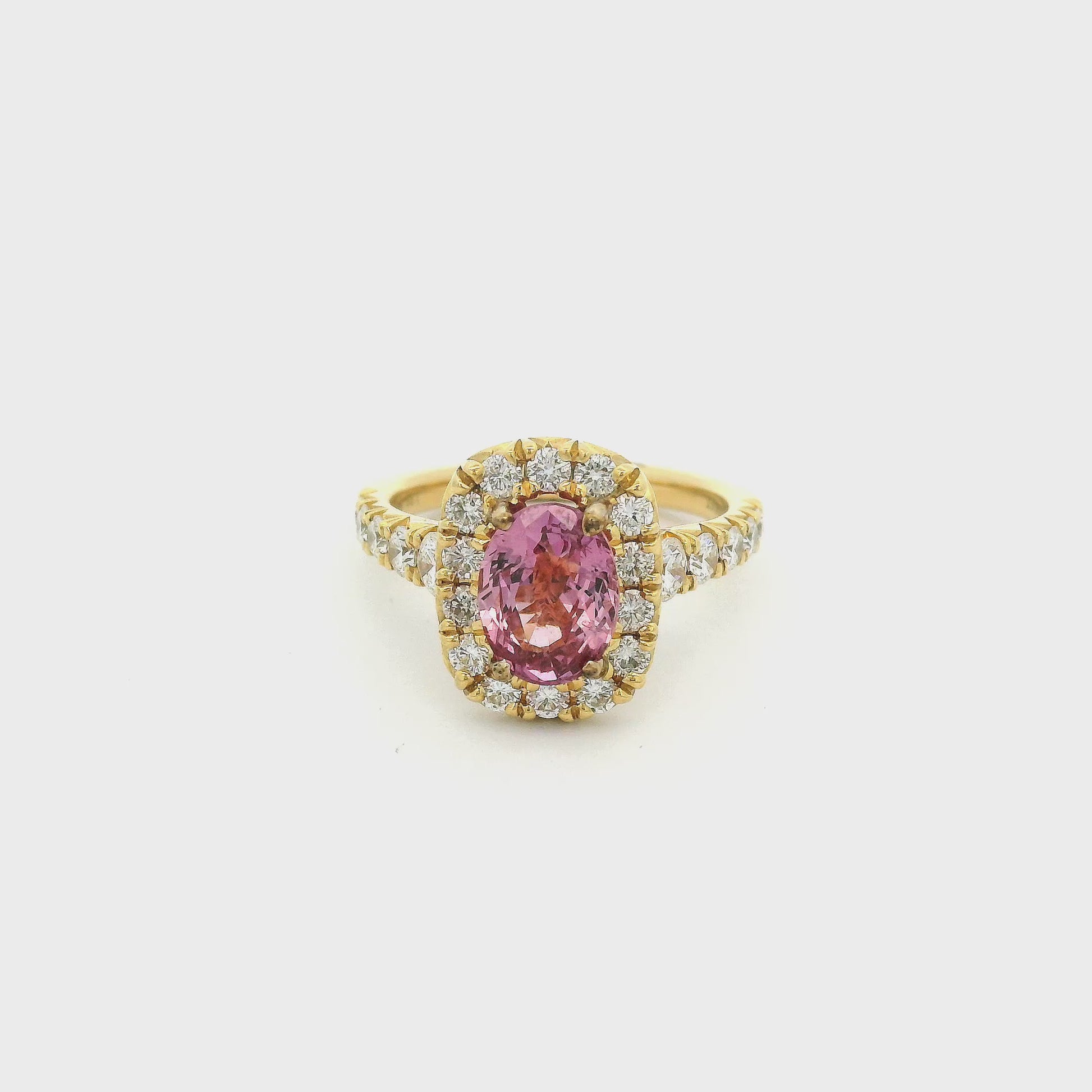 Gold ring with a pink oval ceylonese sapphire set in the center with diamonds at Forever Rox Fine Jewelry 