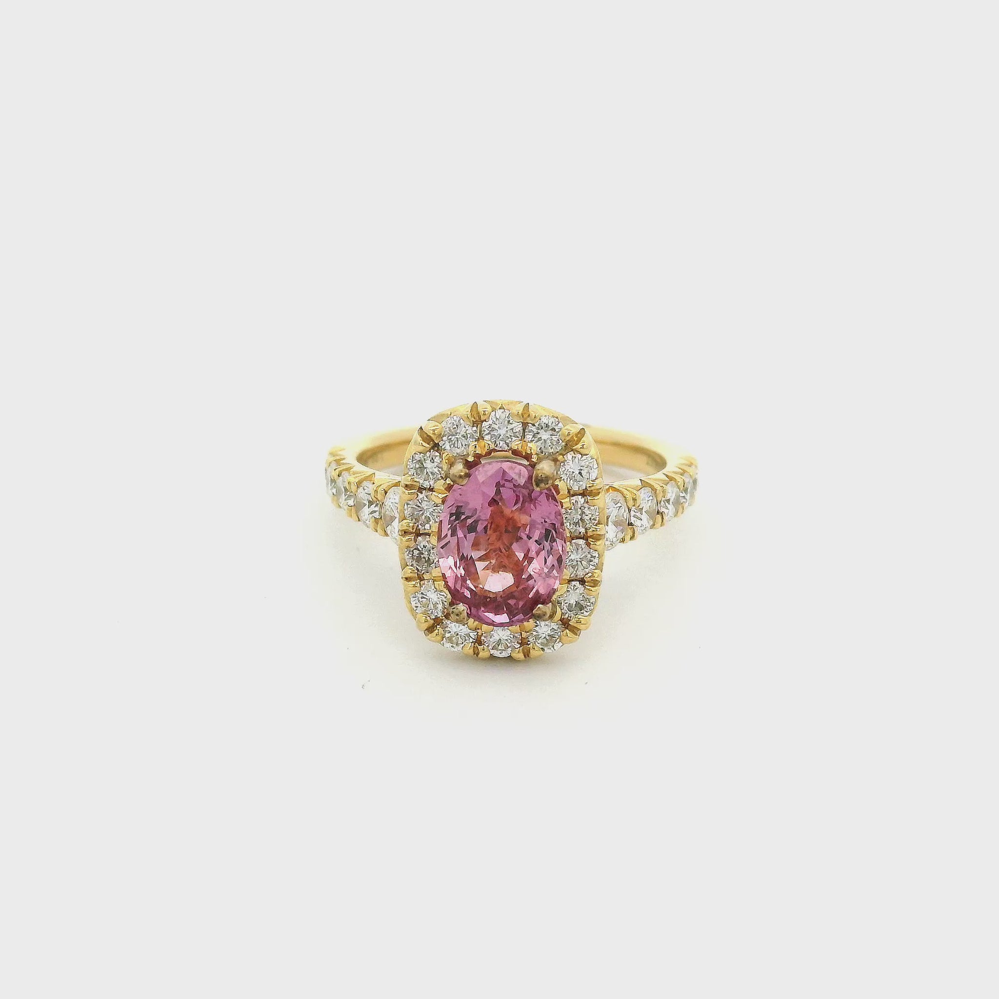 Gold ring with a pink oval ceylonese sapphire set in the center with diamonds at Forever Rox Fine Jewelry 
