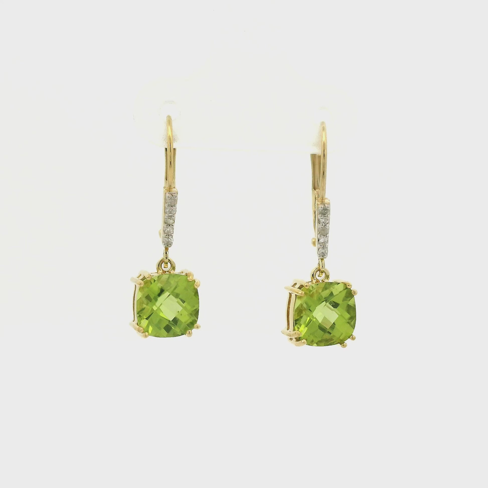A Pair of Yellow Gold Dangle Earrings with prong set fancy cushion cut natural Peridots at the bottom with 4 diamonds dangle at Forever Rox Fine Jewelry, Lake Tahoes Best Jewelry Store
