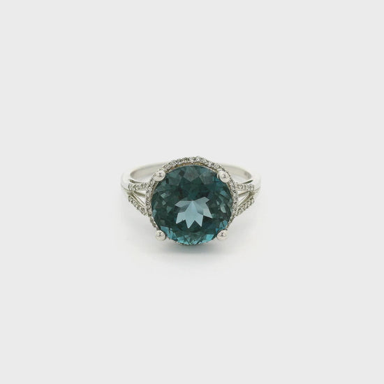 A White Gold Ring with a prong set round cut London Blue Topaz  in the center and a diamond halo surround the center stone with diamonds going down the split band at Forever Rox Fine Jewelry, Lake Tahoes Best Jewelry Store