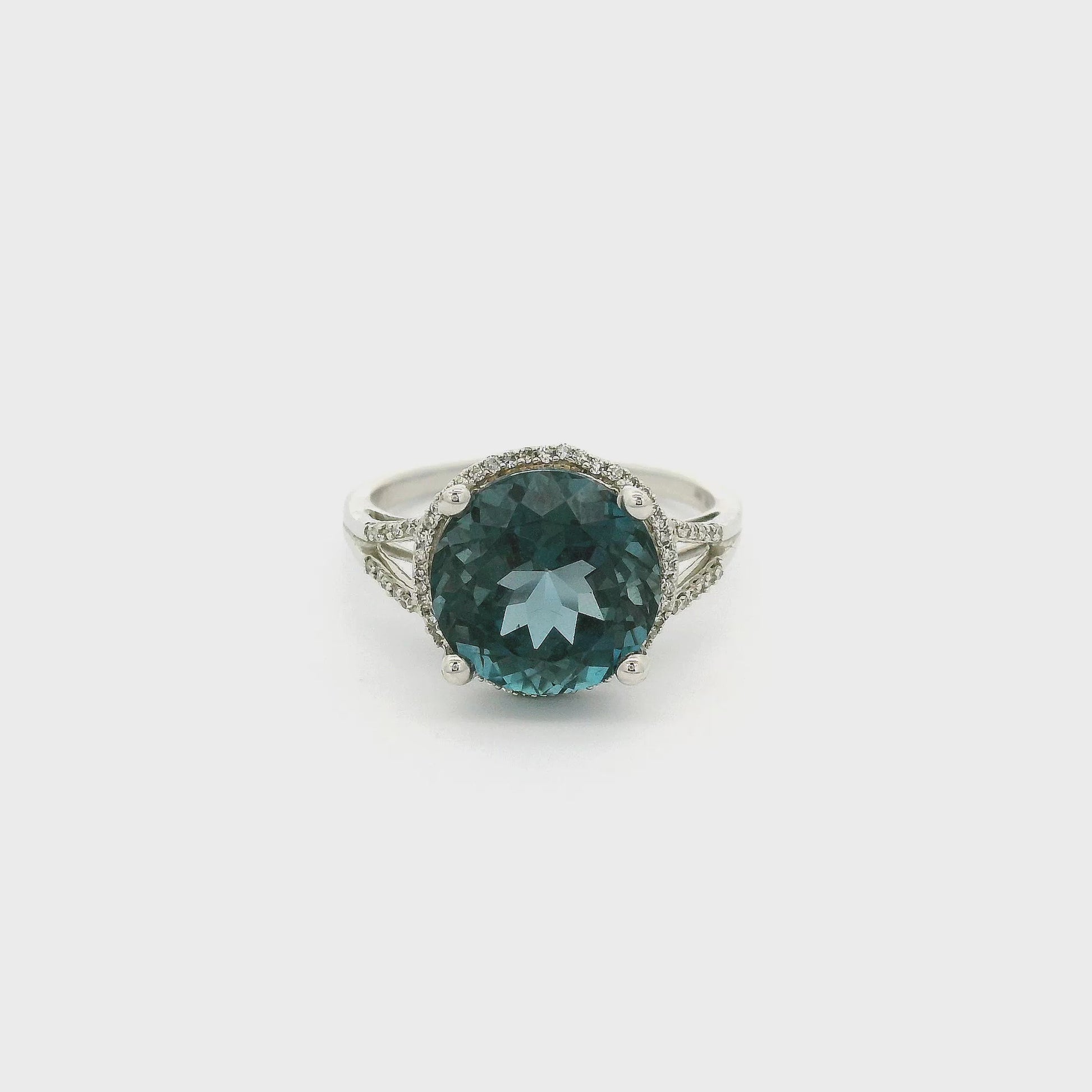 A White Gold Ring with a prong set round cut London Blue Topaz  in the center and a diamond halo surround the center stone with diamonds going down the split band at Forever Rox Fine Jewelry, Lake Tahoes Best Jewelry Store