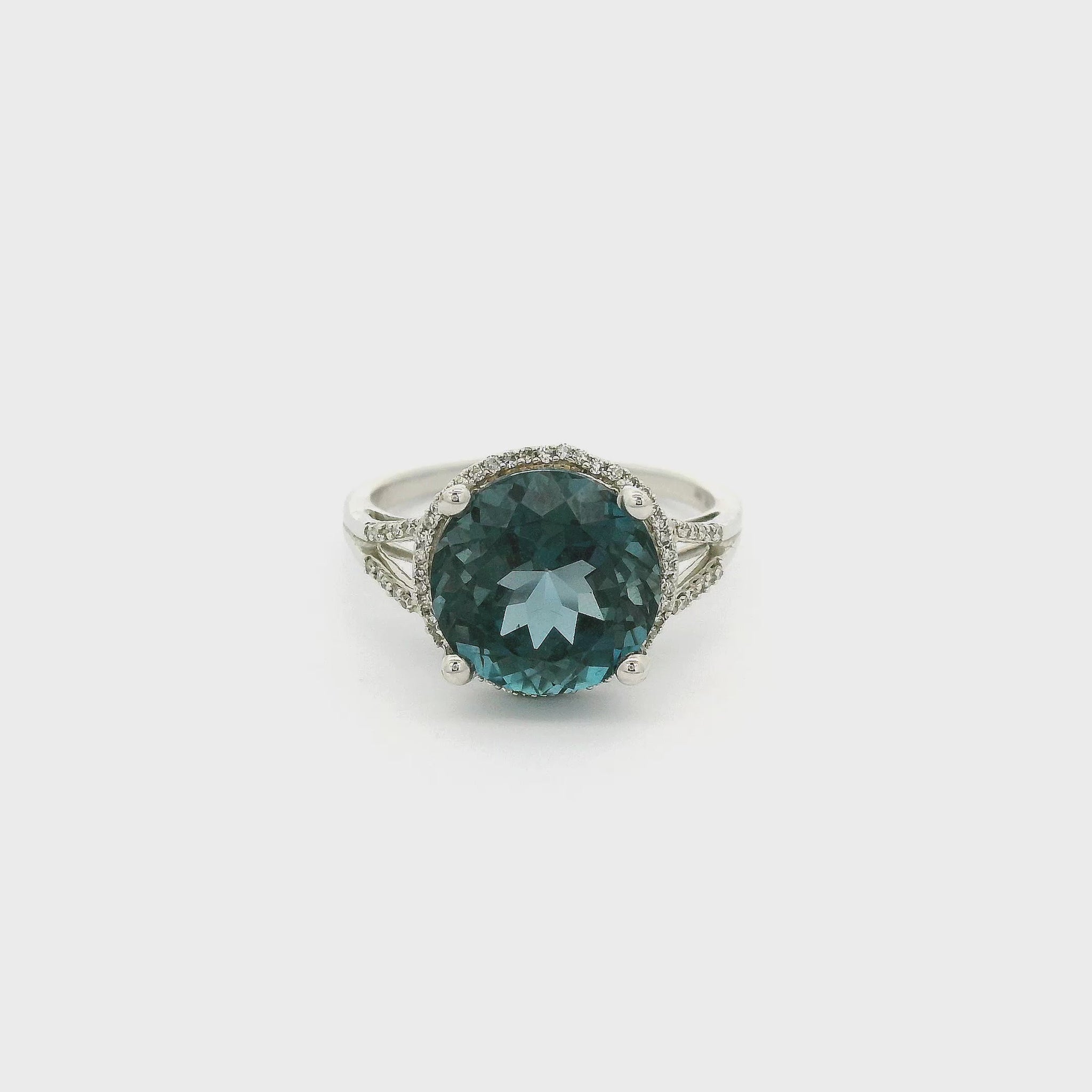 A White Gold Ring with a prong set round cut London Blue Topaz  in the center and a diamond halo surround the center stone with diamonds going down the split band at Forever Rox Fine Jewelry, Lake Tahoes Best Jewelry Store