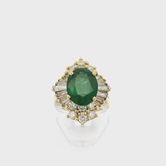 A Yellow Gold Ring with a prong set oval cut Emerald in the center and with baguette & round cut Diamonds around it at Forever Rox Fine Jewelry, Lake Tahoes Best Jewelry Store