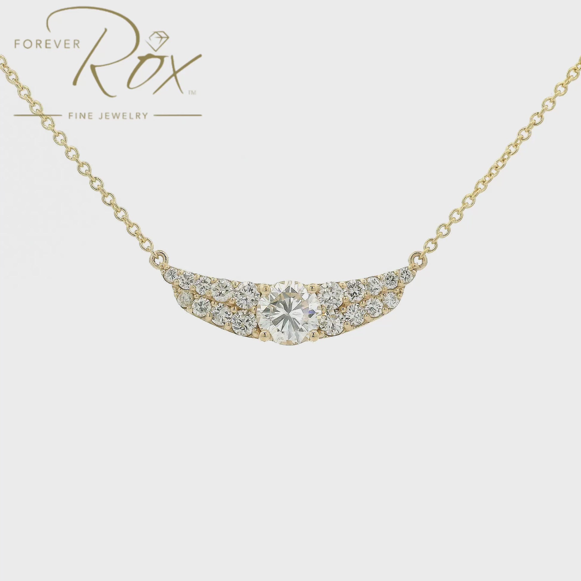 This custom pendant showcases a breathtaking 1.85 carat round brilliant-cut diamond at its center, gracefully set within a flowing curved design crafted in 14k yellow gold. Accented by a cascade of smaller diamonds along each side, the pendant creates a beautiful balance of brilliance and elegance. Designed to highlight the exceptional center stone, this timeless custom piece offers a refined look with sparkle from every angle.