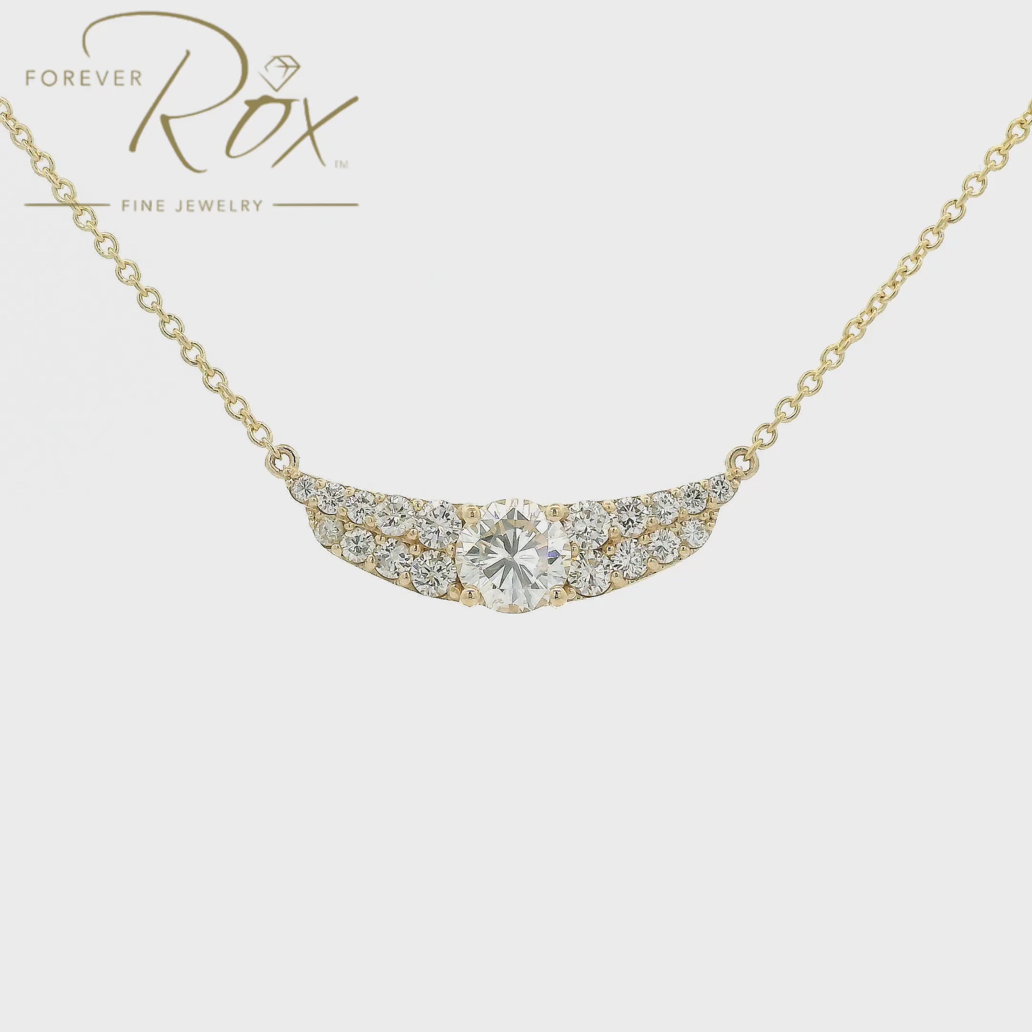 This custom pendant showcases a breathtaking 1.85 carat round brilliant-cut diamond at its center, gracefully set within a flowing curved design crafted in 14k yellow gold. Accented by a cascade of smaller diamonds along each side, the pendant creates a beautiful balance of brilliance and elegance. Designed to highlight the exceptional center stone, this timeless custom piece offers a refined look with sparkle from every angle.