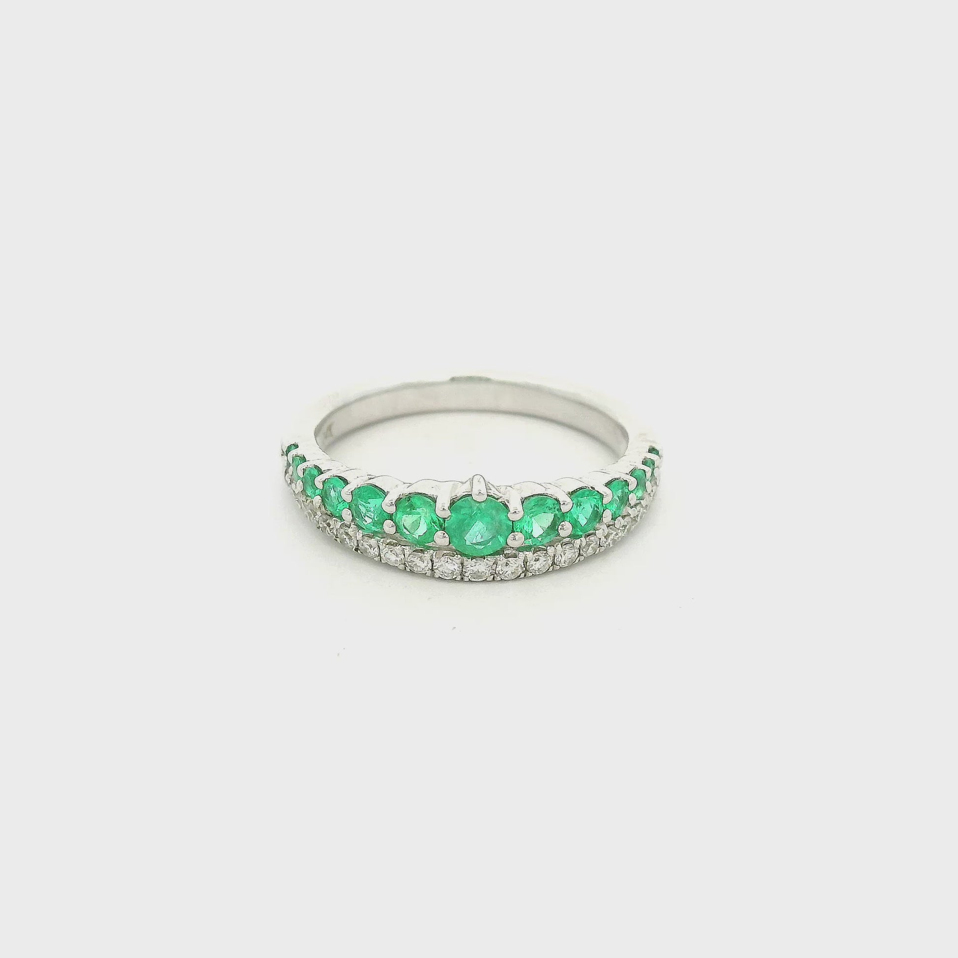 White Gold band with graduating size emeralds on hal the ring and round cut diamonds on the other half at Forever Rox Fine Jewelry 