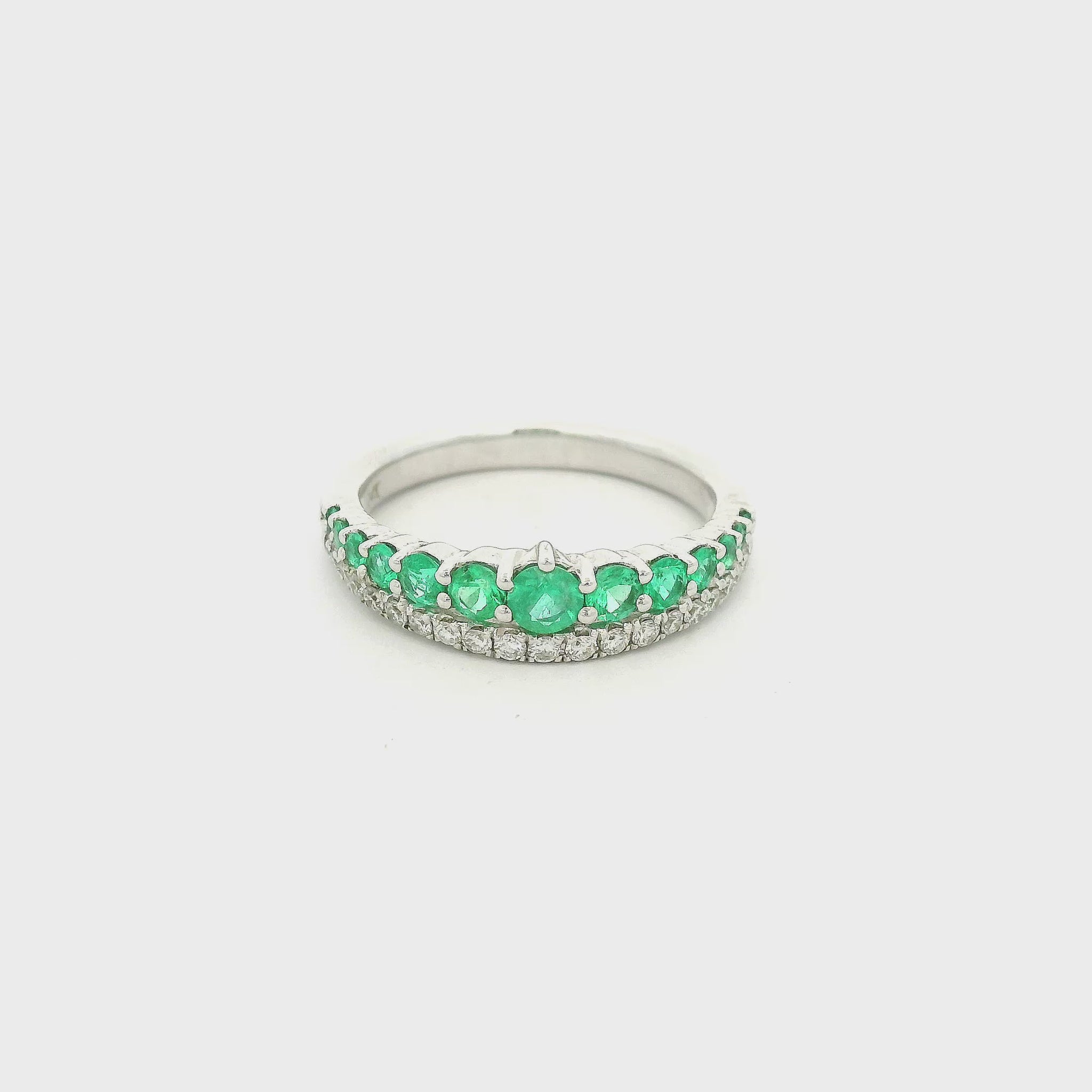 White Gold band with graduating size emeralds on hal the ring and round cut diamonds on the other half at Forever Rox Fine Jewelry 