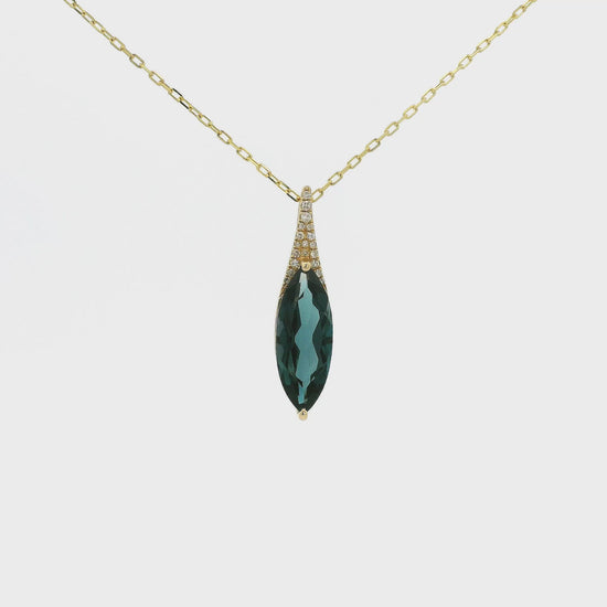 A Yellow Gold Pendant with a long prong set marquise cut natural London Blue Topaz in the center with diamonds at Forever Rox Fine Jewelry, Lake Tahoes Best Jewelry Store