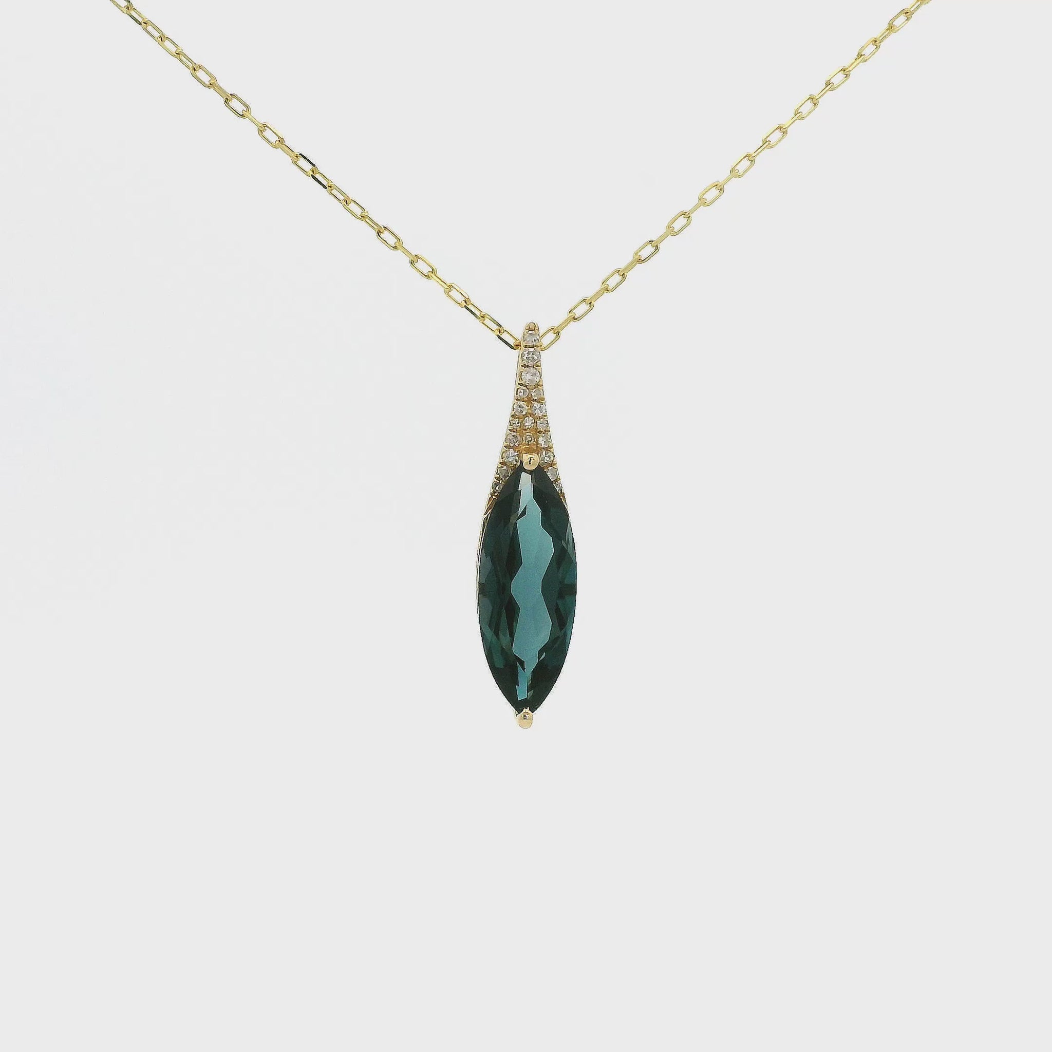 A Yellow Gold Pendant with a long prong set marquise cut natural London Blue Topaz in the center with diamonds at Forever Rox Fine Jewelry, Lake Tahoes Best Jewelry Store