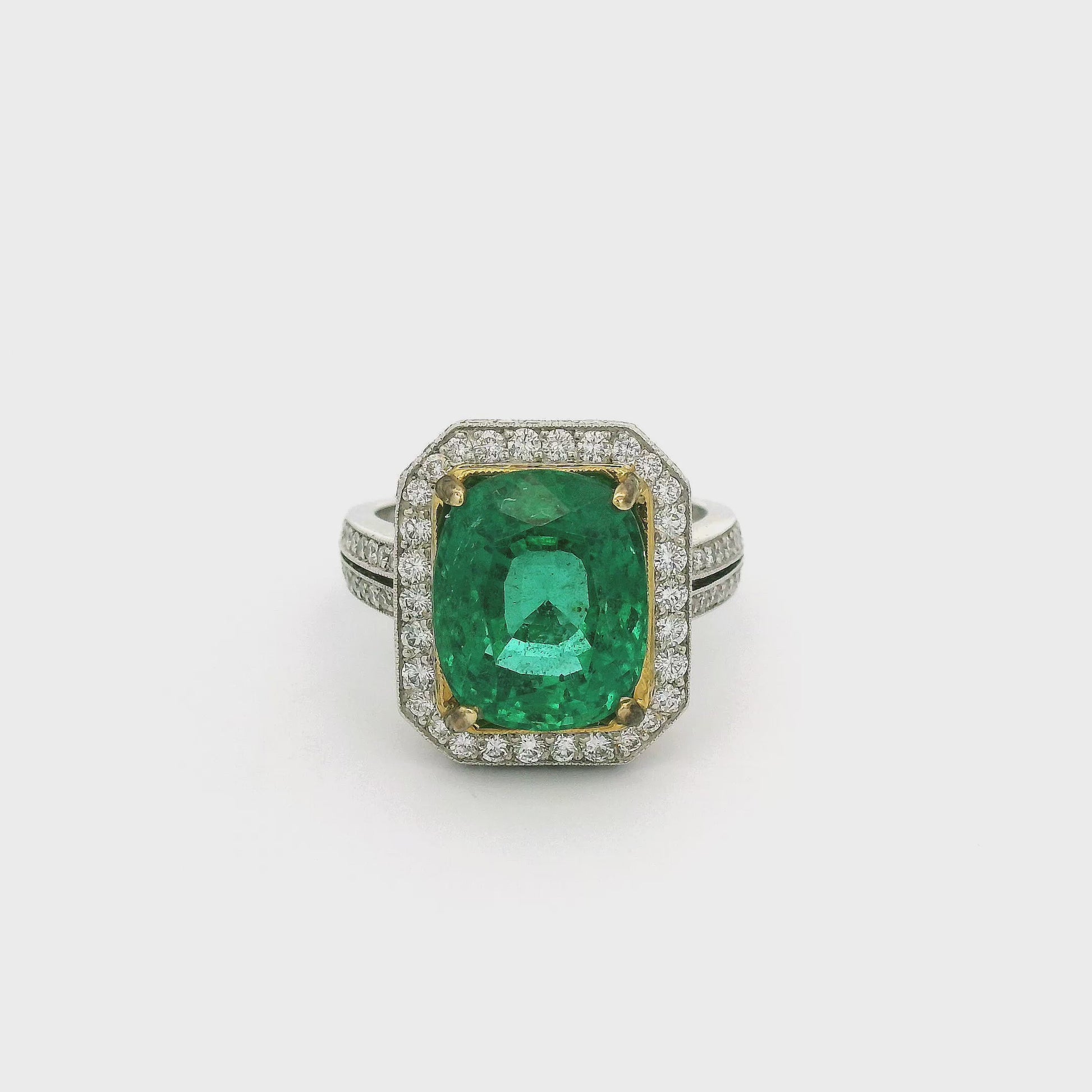A White Gold Ring with a prong set in yellow gold cushion cut African Emerald in the center and diamond accents around the top and side of the head and down the shank at Forever Rox Fine Jewelry, Lake Tahoes Best Jewelry Store
