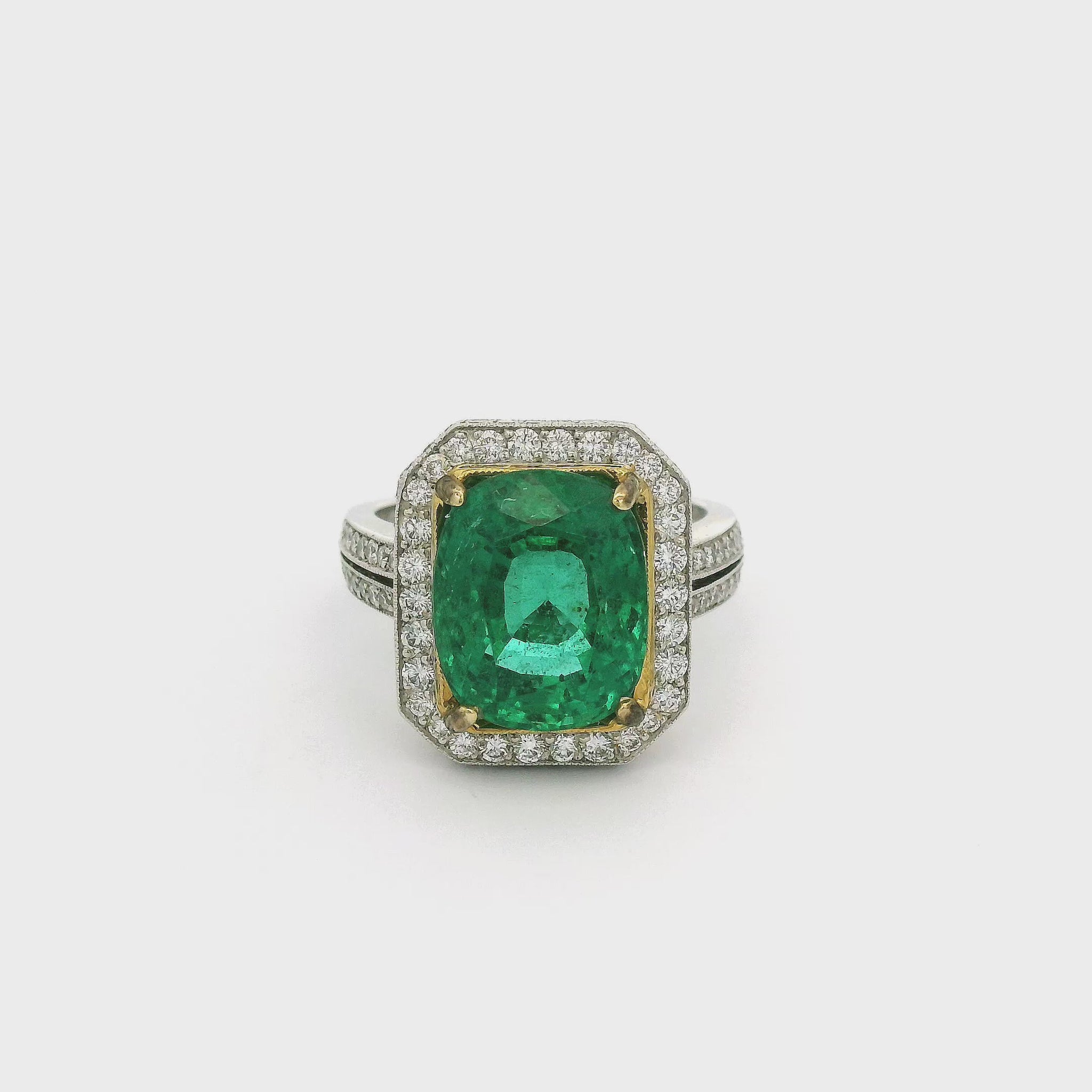 A White Gold Ring with a prong set in yellow gold cushion cut African Emerald in the center and diamond accents around the top and side of the head and down the shank at Forever Rox Fine Jewelry, Lake Tahoes Best Jewelry Store