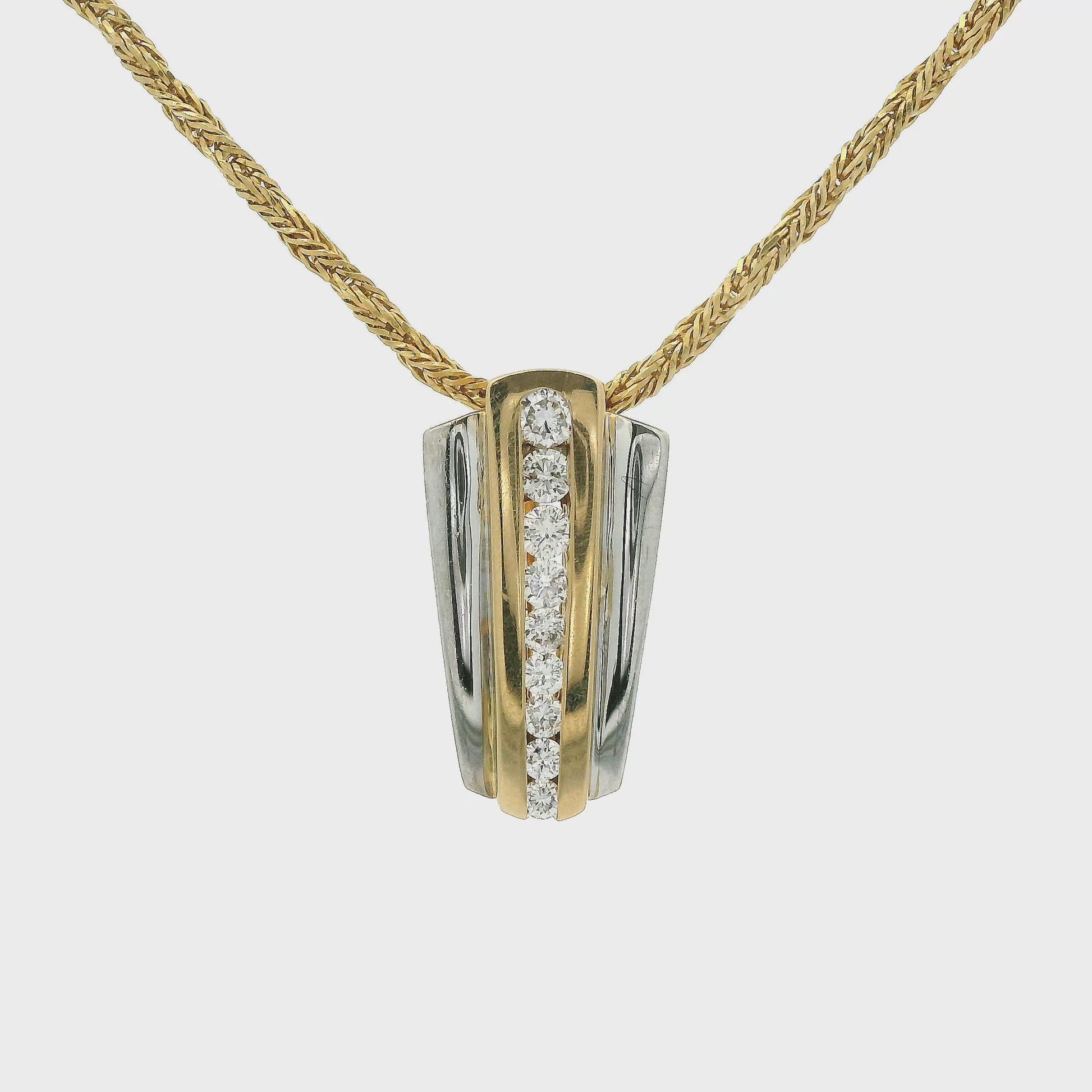 Two Tone Pendant with nine graduating size diamonds from small to large set in the center with an enhancer bail at Forever Rox Fine Jewelry
