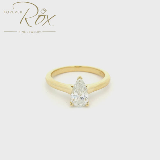 A Custom Yellow Gold Ring with a bezel set a solitaire pear cut Diamond at Forever Rox Fine Jewelry, Lake Tahoes Best Jewelry Store