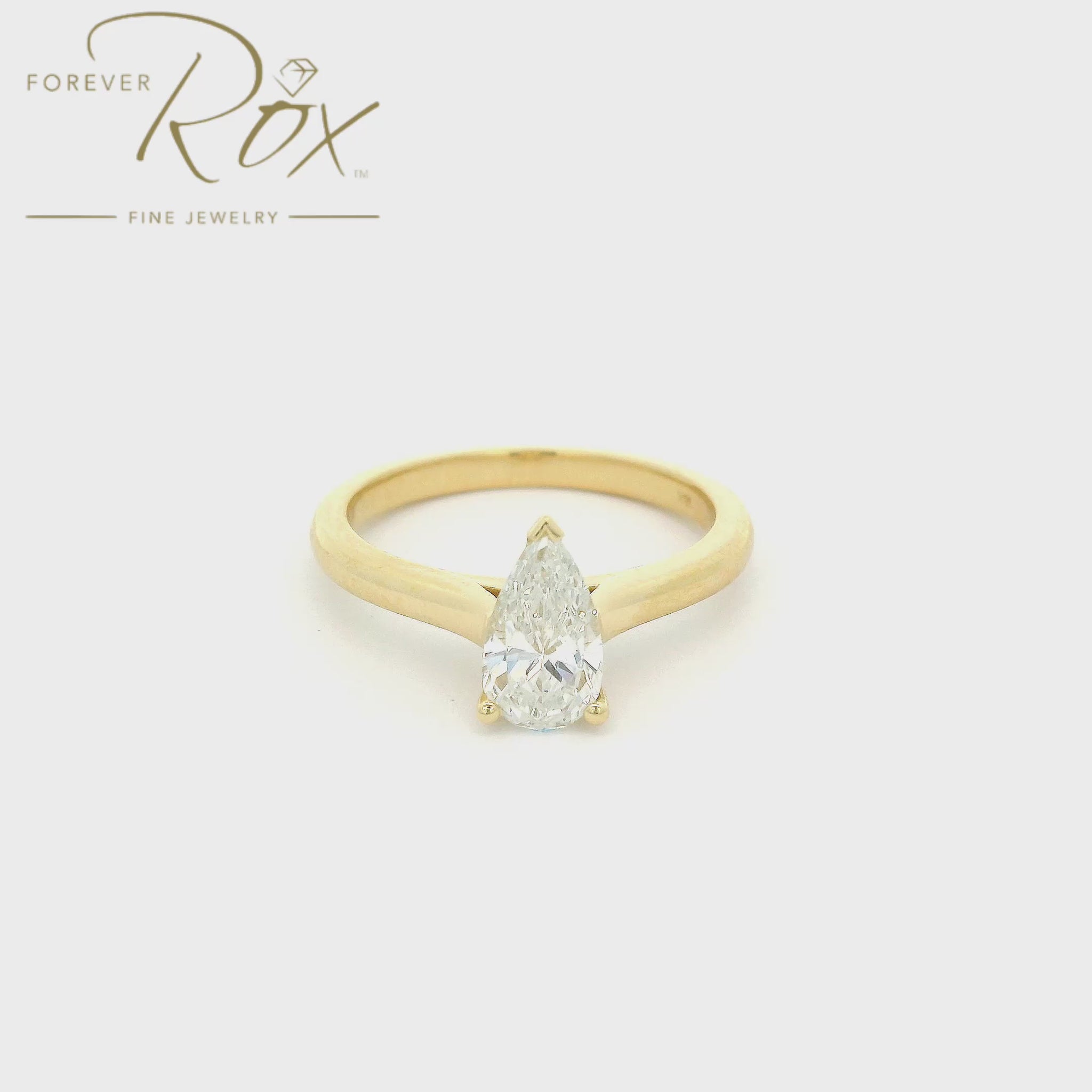 A Custom Yellow Gold Ring with a bezel set a solitaire pear cut Diamond at Forever Rox Fine Jewelry, Lake Tahoes Best Jewelry Store