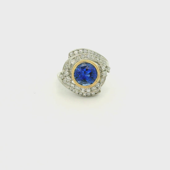 A Vintage Platinum & Yellow Gold Ring with a milgrain bezel set round cut natural Fine Blue Sapphire in the center with diamonds scattered around at Forever Rox Fine Jewelry, Lake Tahoes Best Jewelry Store
