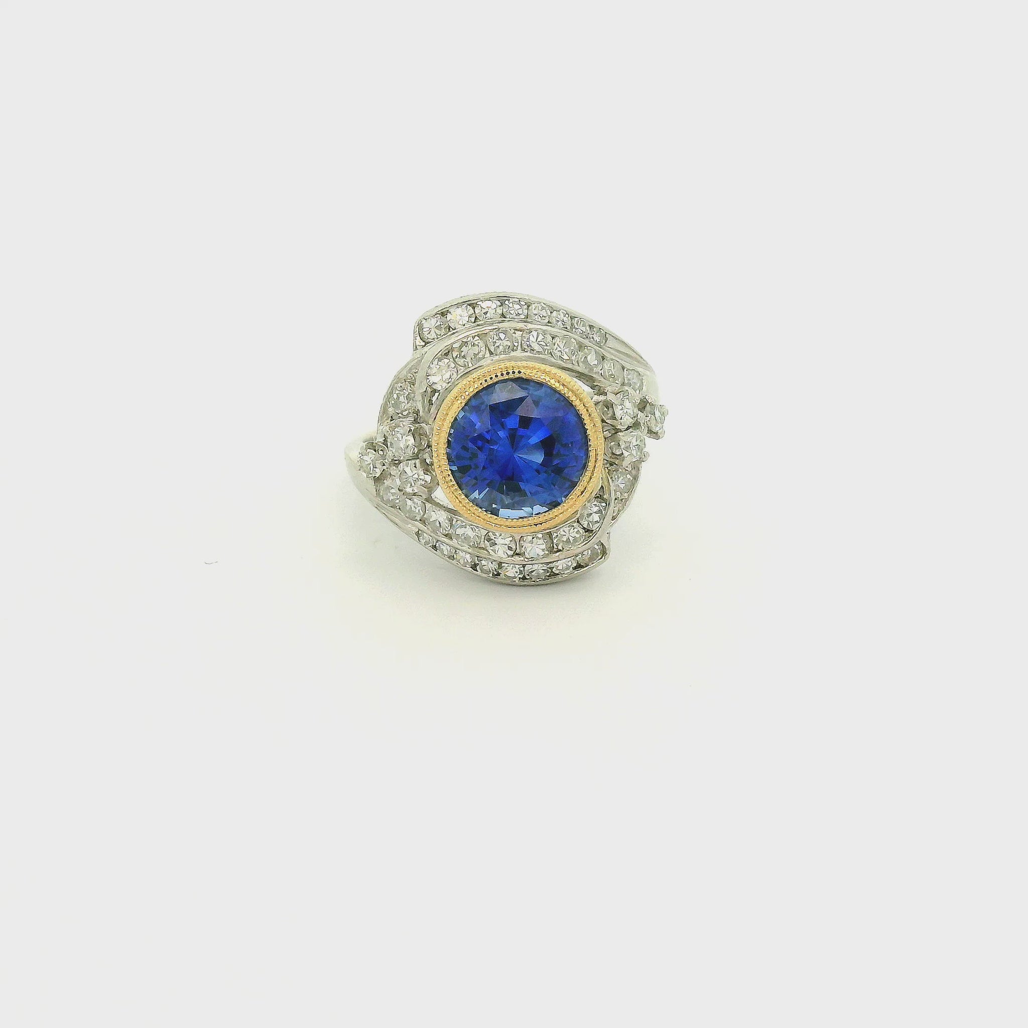 A Vintage Platinum & Yellow Gold Ring with a milgrain bezel set round cut natural Fine Blue Sapphire in the center with diamonds scattered around at Forever Rox Fine Jewelry, Lake Tahoes Best Jewelry Store
