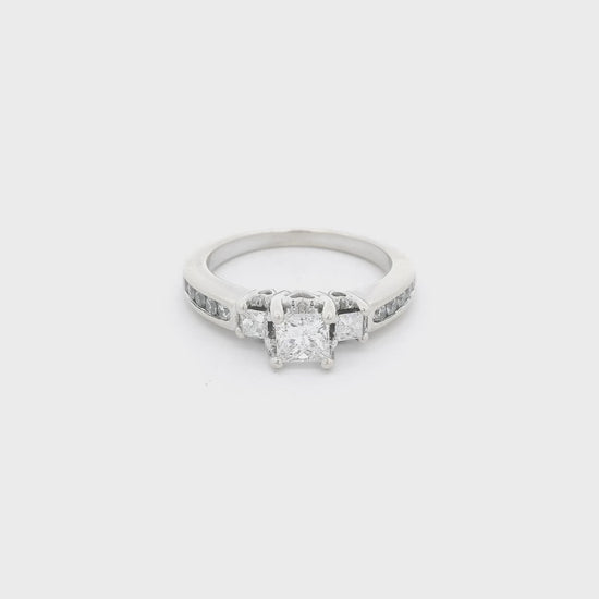 White Gold ring with three princess cut diamonds in the center and four round cut diamonds channel set down each side of the shank and 2 diamonds inside the shank at Forever Rox Fine Jewelry