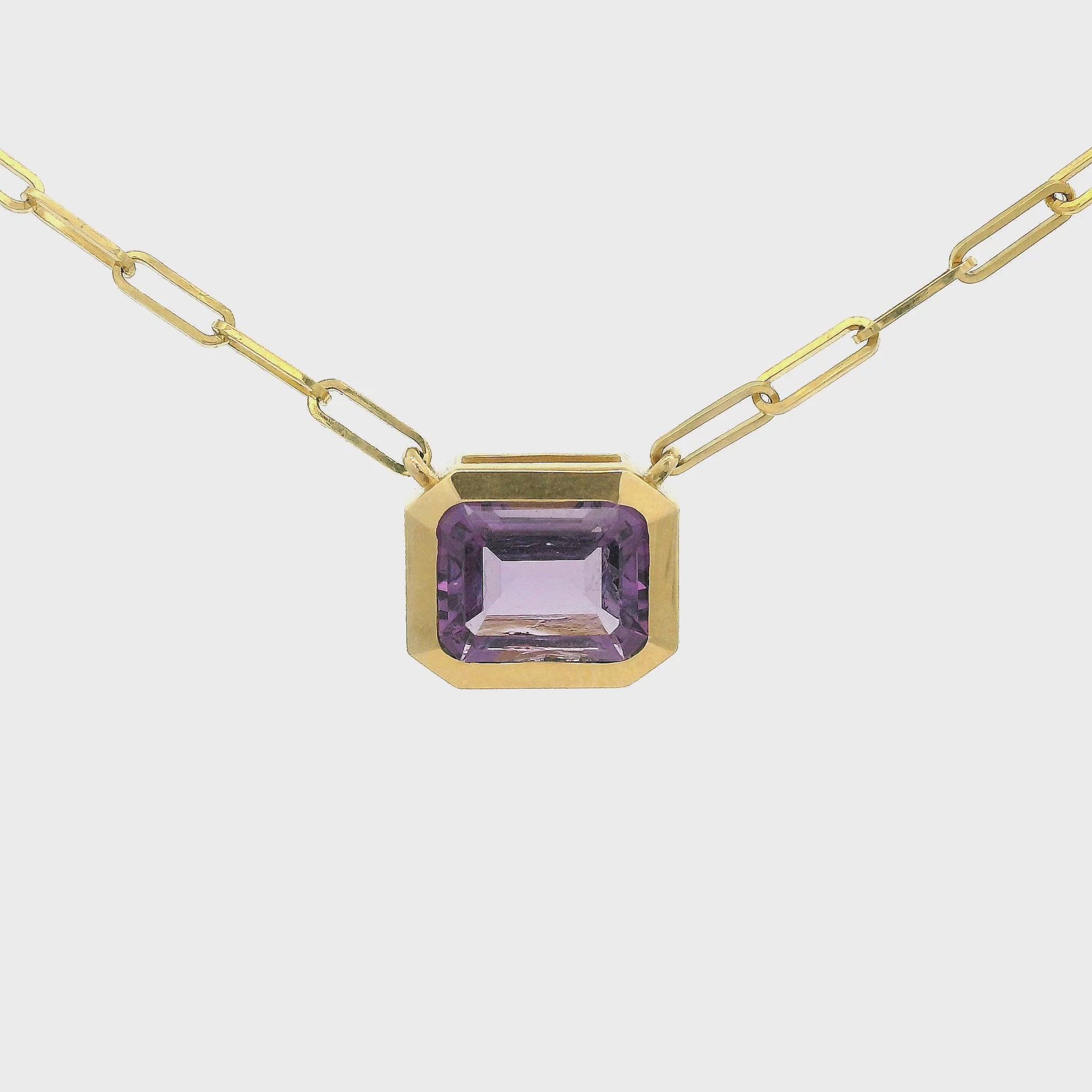 Gold Pendant with a Emerald cur Amethyst in the center attached to a paperclip chain at Forever Rox Fine Jewelry