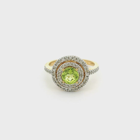 A Yellow Gold Ring with a prong set round cut Peridot  in the center and a double level diamond halo surrounding the center stone with diamonds going down the shank at Forever Rox Fine Jewelry, Lake Tahoes Best Jewelry Store