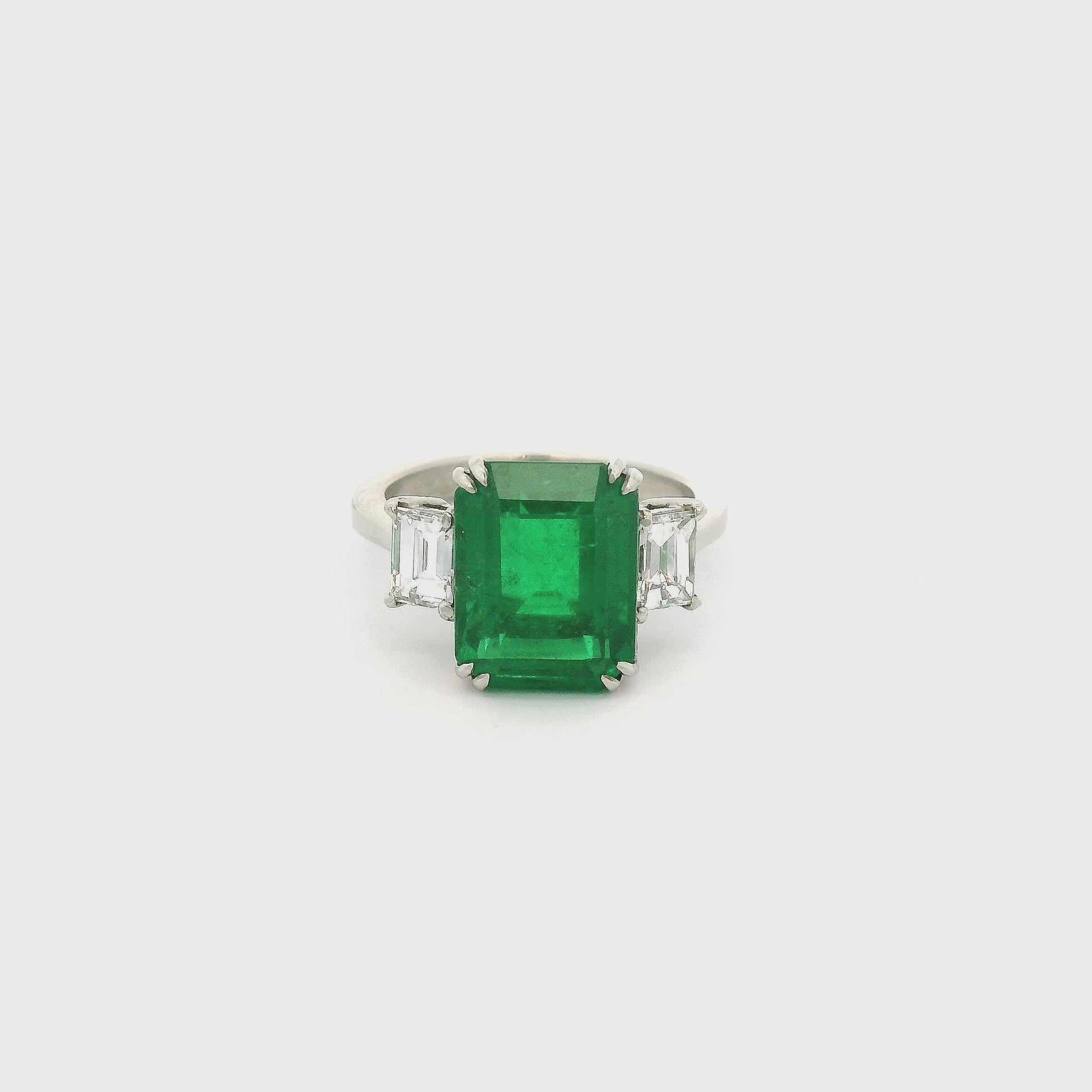 A Platinum Ring with a prong set emerald cut natural Certified F1 Emerald in the center with two emerald cut Diamonds at Forever Rox Fine Jewelry, Lake Tahoes Best Jewelry Store