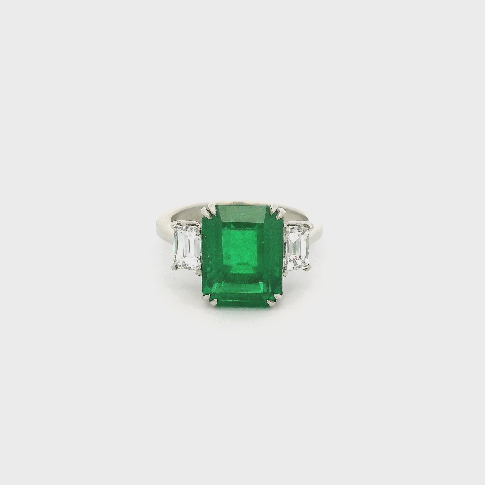 A Platinum Ring with a prong set emerald cut natural Certified F1 Emerald in the center with two emerald cut Diamonds at Forever Rox Fine Jewelry, Lake Tahoes Best Jewelry Store