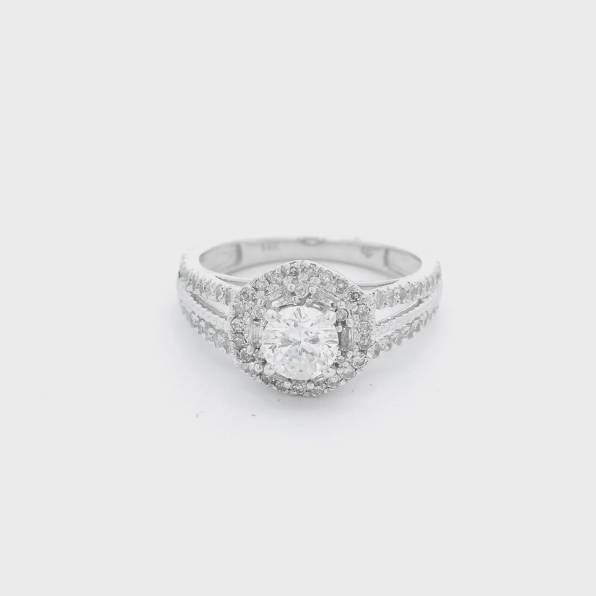 White Gold ring with a round cut diamond in the center, baguette & round cut diamond halo and diamond accent split shank with milgrain design down the center at Forever Rox Fine Jewelry