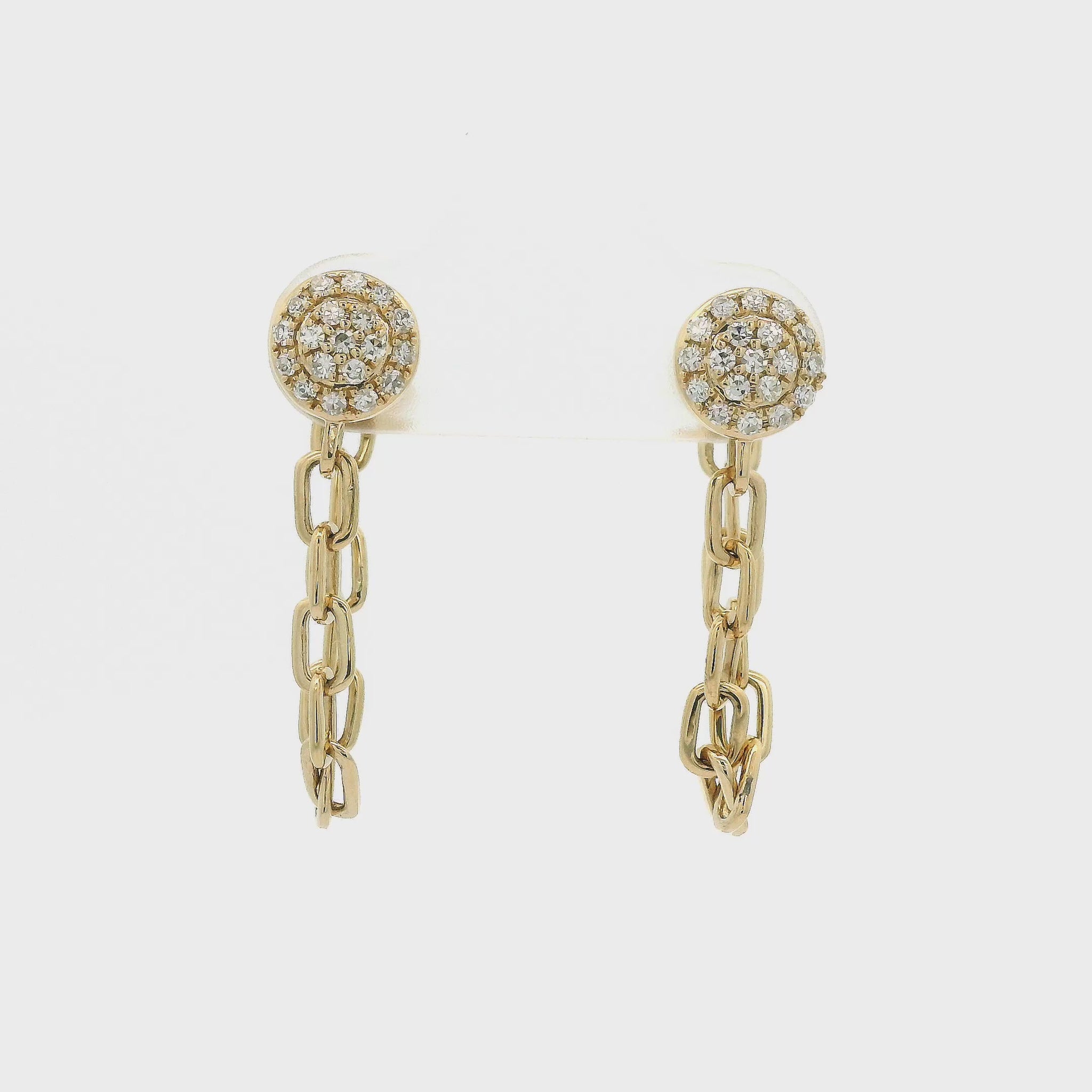 A Pair of Yellow Gold Stud Earrings with pavé set natural Diamonds in the center with a chain dangling from them at Forever Rox Fine Jewelry, Lake Tahoes Best Jewelry Store