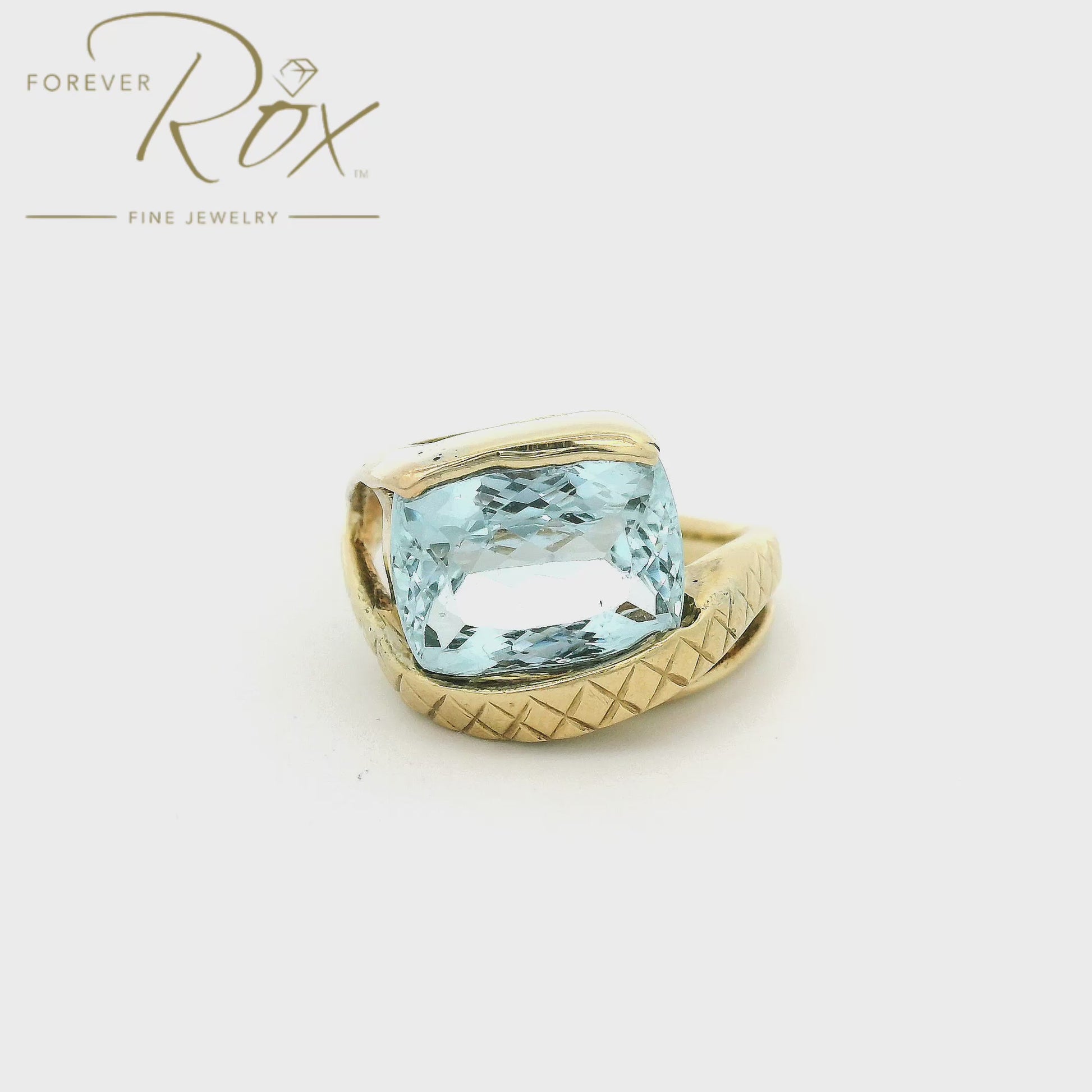 Yellow Gold ring with light blue aquamarine stone set in center and hand carved band at Forever Rox Fine Jewelry 