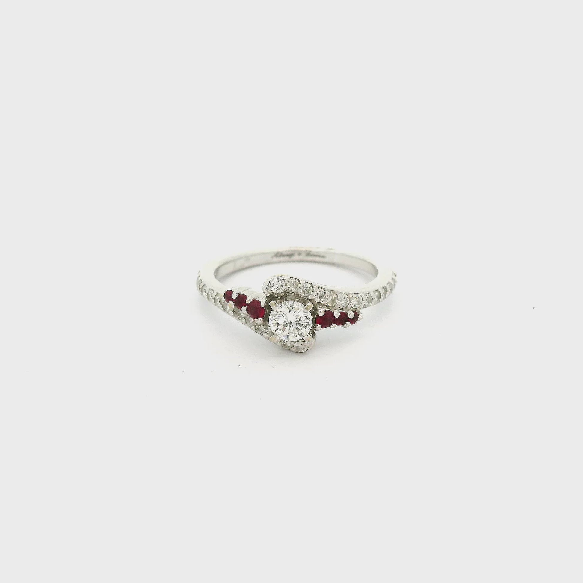 A White Gold Ring with a prong set round cut natural Diamond in the center with rubies & diamonds down the curved shank attached at Forever Rox Fine Jewelry, Lake Tahoes Best Jewelry Store