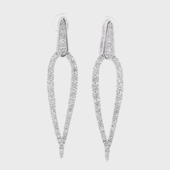 A Pair of White Gold Tear Drop Shape Dangles with a round cut Diamondscovering the earrings at Forever Rox Fine Jewelry, Lake Tahoes Best Jewelry Store