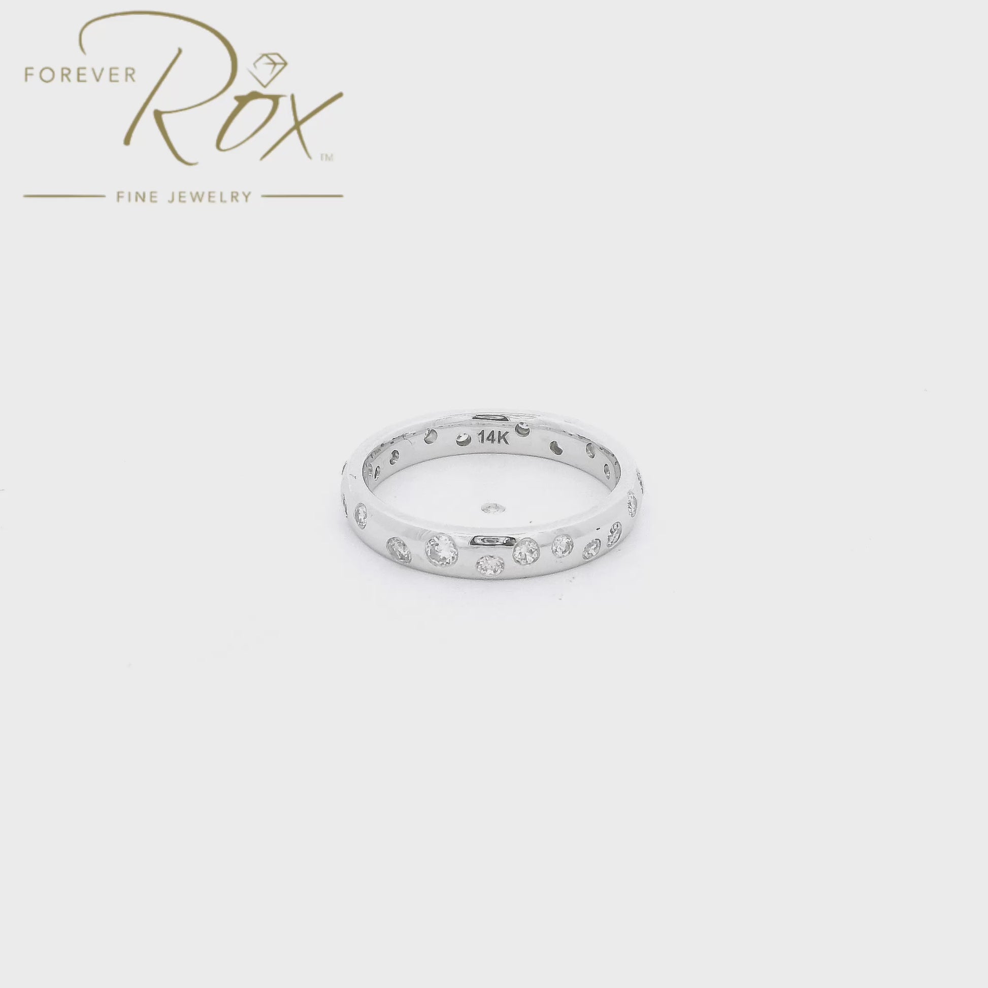 This custom flush-set diamond scatter band is crafted in 14k white gold and features brilliant round diamonds thoughtfully spaced around the band in a modern scattered design. The flush-set construction creates a sleek, low-profile look while allowing each diamond to sparkle from within the metal. Elegant, comfortable, and timeless, this custom piece is perfect as a wedding band, stacking ring, or everyday statement.