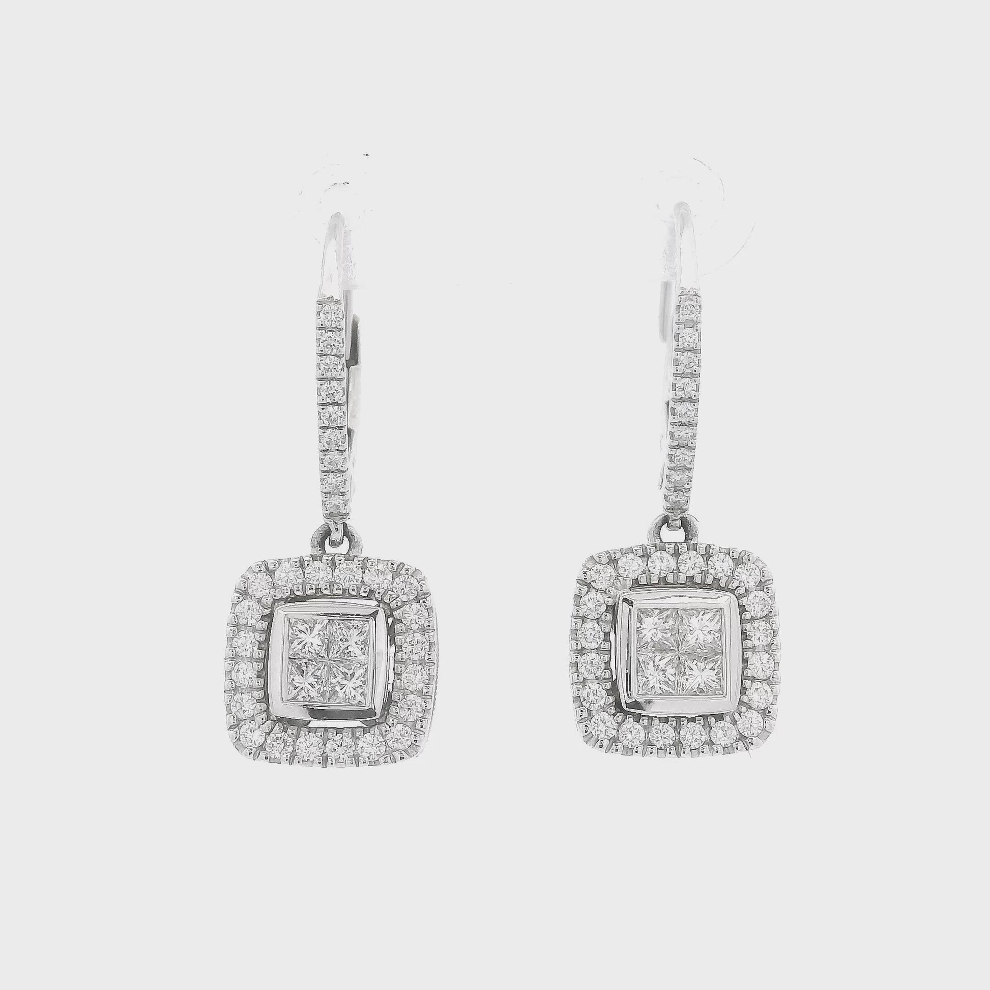 A Pair of White Gold Dangle Earrings with 4 Princess Cut Diamond in the center and round cut diamonds around them and down the hoop at Forever Rox Fine Jewelry