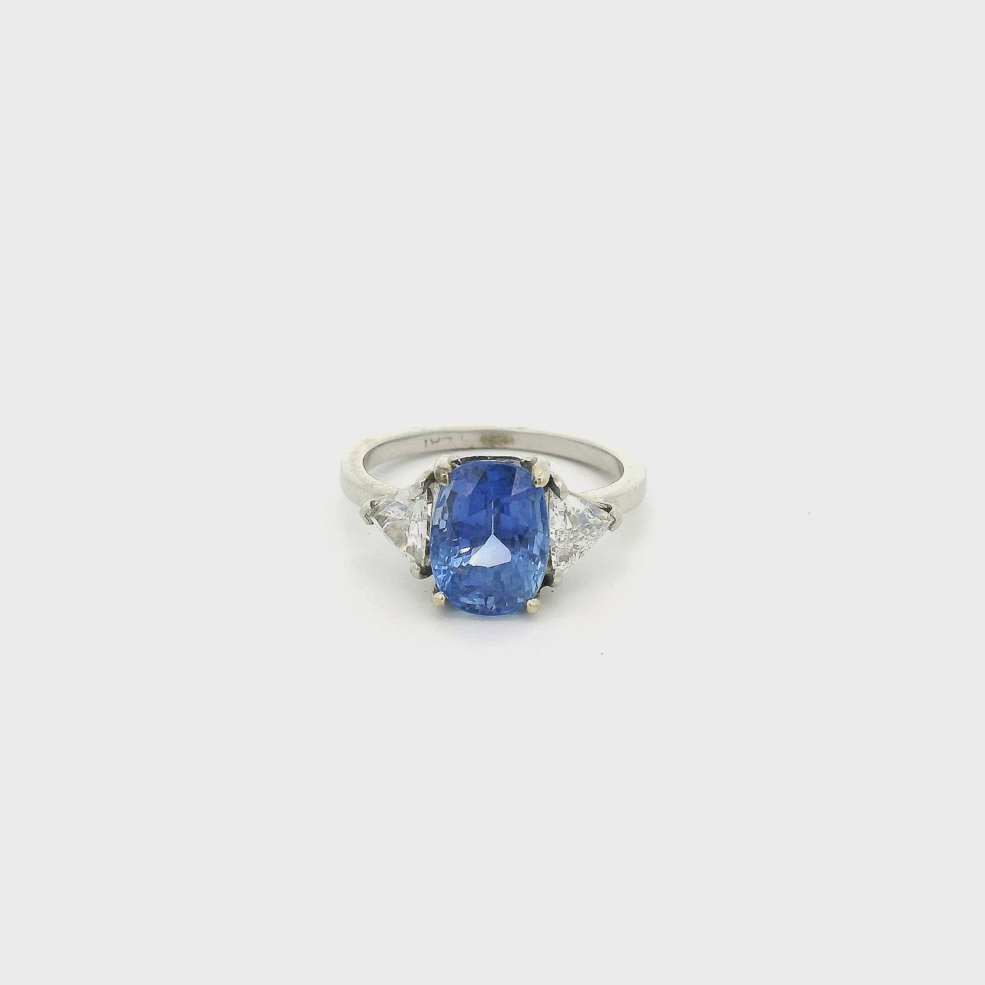 A White Gold Ring with a prong set oval cut natural Certified No Heat Sapphire in the center with two Trillion Cut Diamonds  at Forever Rox Fine Jewelry, Lake Tahoes Best Jewelry Store
