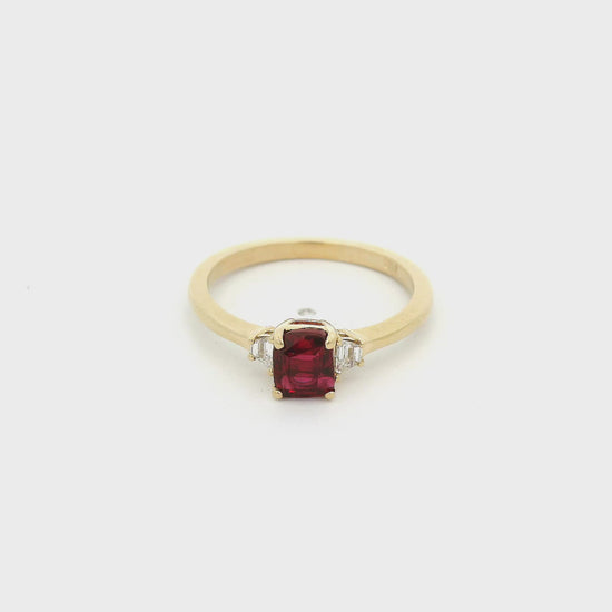 A Yellow Gold Ring with a prong set square cushion cut natural Certified No Heat Ruby in the center with two trapazoid cut diamonds at Forever Rox Fine Jewelry, Lake Tahoes Best Jewelry Store
