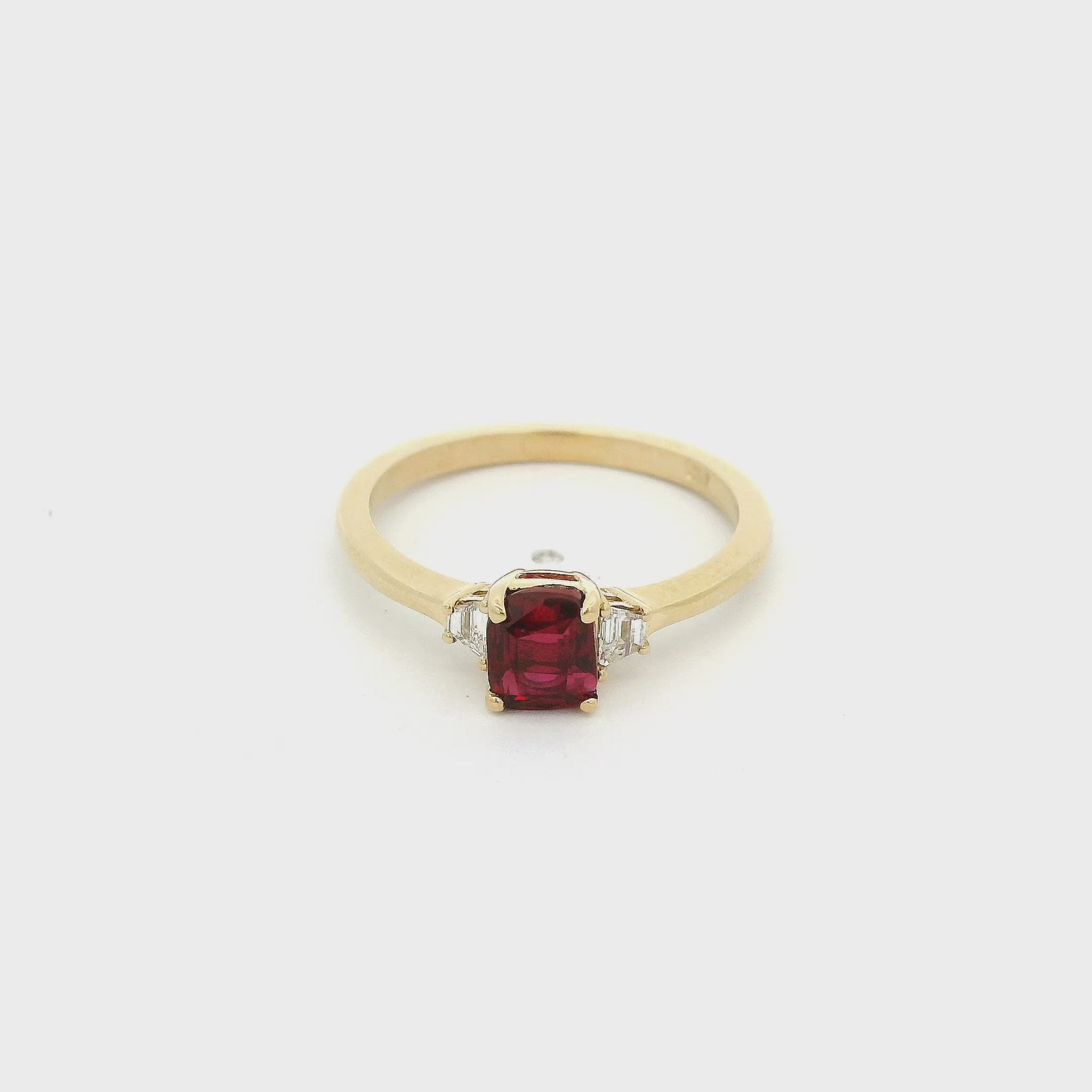 A Yellow Gold Ring with a prong set square cushion cut natural Certified No Heat Ruby in the center with two trapazoid cut diamonds at Forever Rox Fine Jewelry, Lake Tahoes Best Jewelry Store

