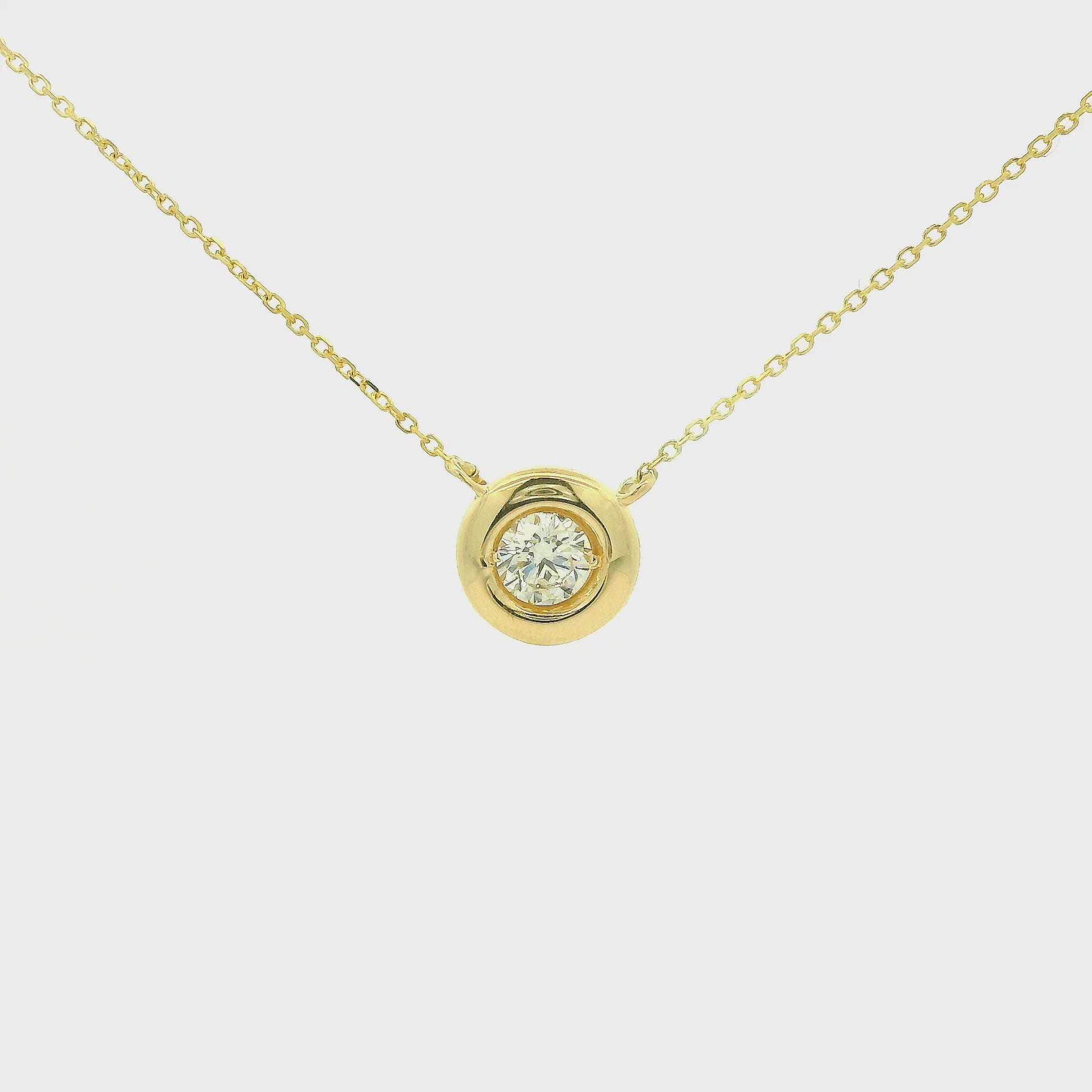 A Yellow Gold Pendant with a bezel set round cut natural Diamond in the center with a chain attached at Forever Rox Fine Jewelry, Lake Tahoes Best Jewelry Store
