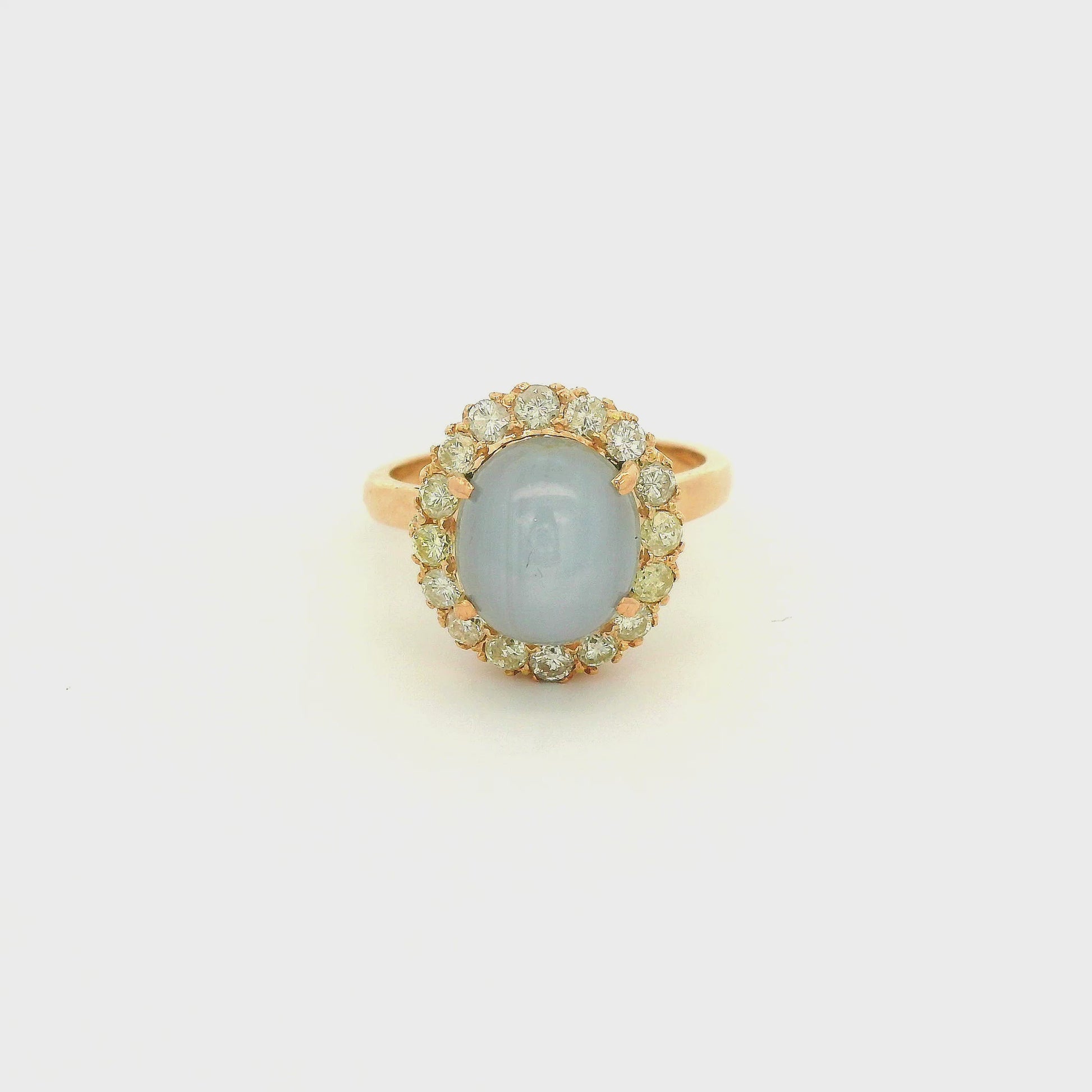 A Rose Gold Ring with a prong set cabochon cut natural Star Sapphire in the center with a diamond halo at Forever Rox Fine Jewelry, Lake Tahoes Best Jewelry Store