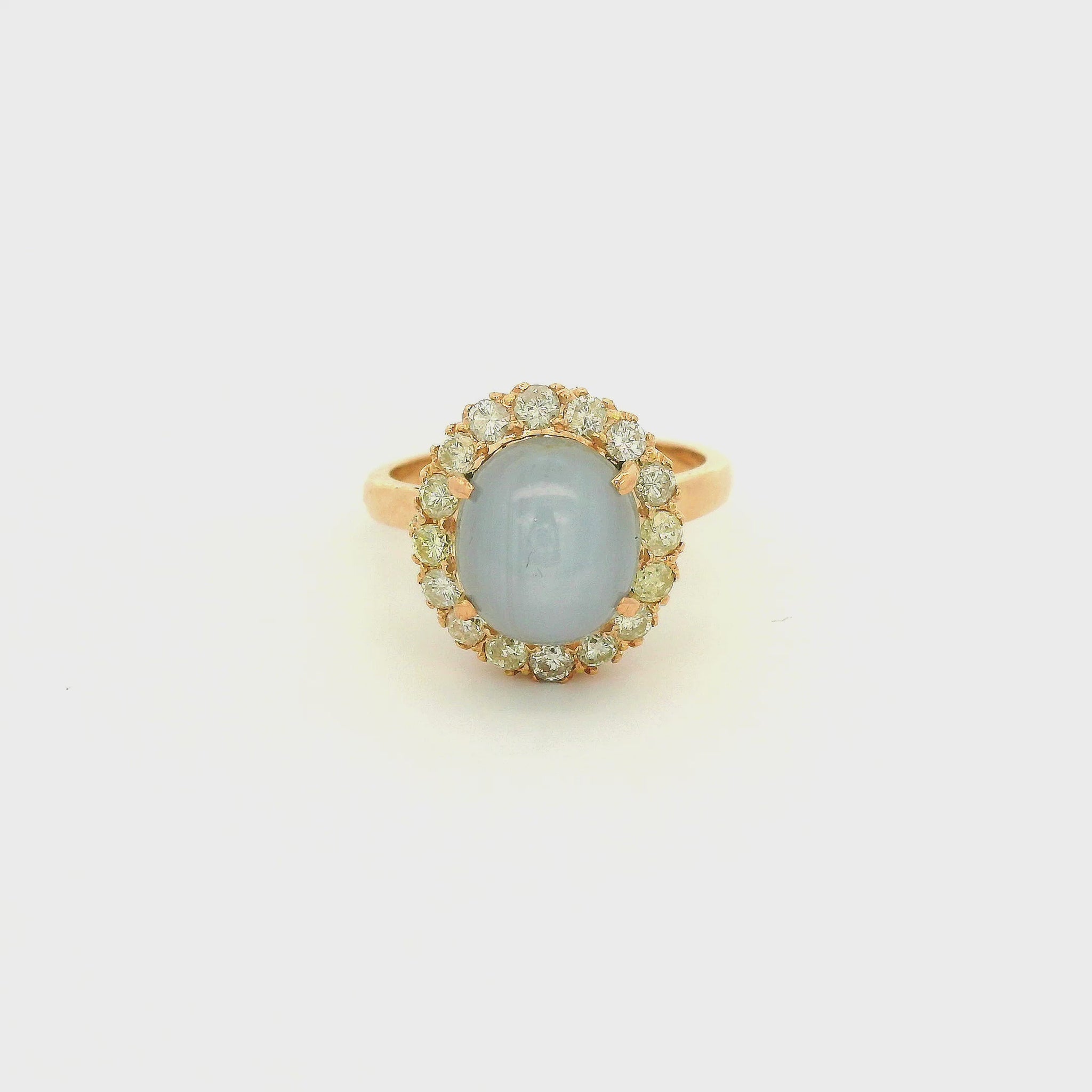 A Rose Gold Ring with a prong set cabochon cut natural Star Sapphire in the center with a diamond halo at Forever Rox Fine Jewelry, Lake Tahoes Best Jewelry Store
