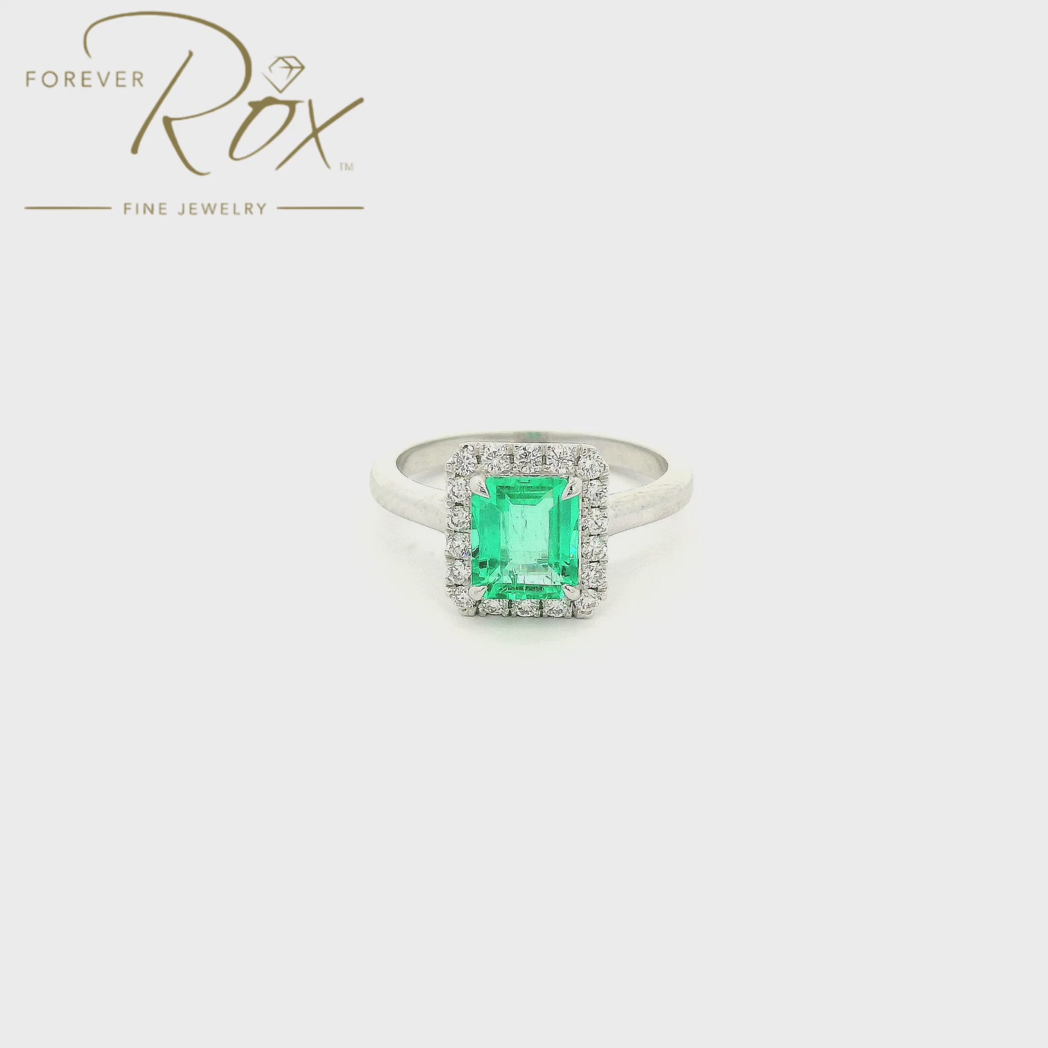 Custom 14k white gold ring featuring a 1.05ct emerald-cut Colombian emerald with a 0.22ctw diamond halo by Forever Rox Fine Jewelry, Lake Tahoes Best Jewelry Store