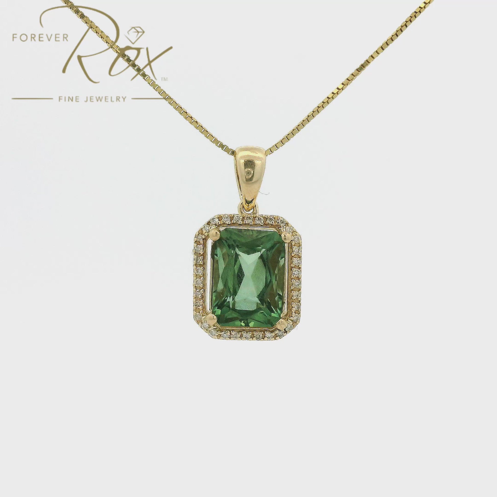 A Yellow Gold Pendant with a prong set emerald cut natural Mint Tourmaline in the center with a halow of diamonds at Forever Rox Fine Jewelry, Lake Tahoes Best Jewelry Store