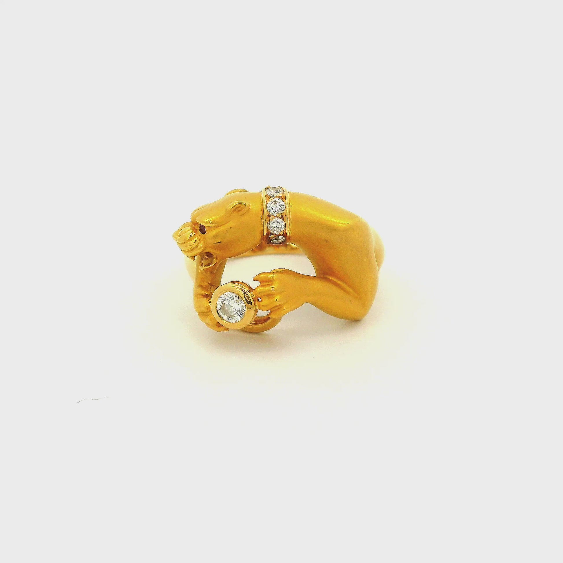 A Yellow Gold Ring Signed Carrera Y Carrera with a bezel set round cut natural Diamond in the center of the paws with a diamond collar and Ruby eye at Forever Rox Fine Jewelry, Lake Tahoes Best Jewelry Store
