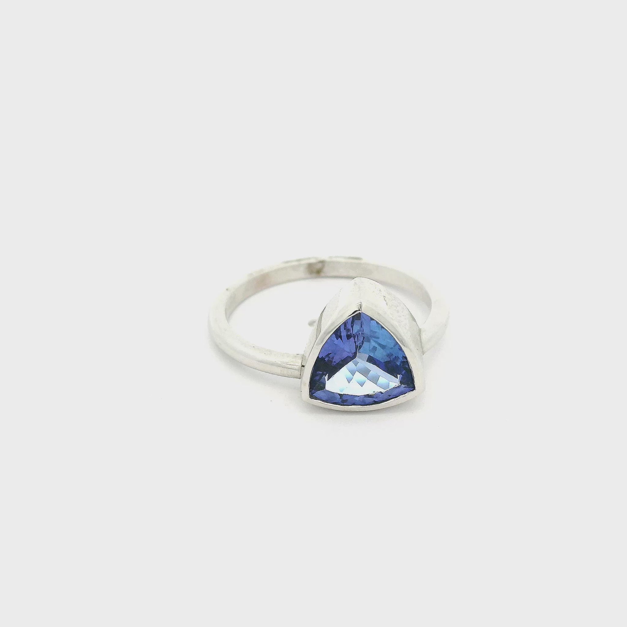 A White Gold Ring with a bezel set trillion cut natural Tanzanite in the center at Forever Rox Fine Jewelry, Lake Tahoes Best Jewelry Store